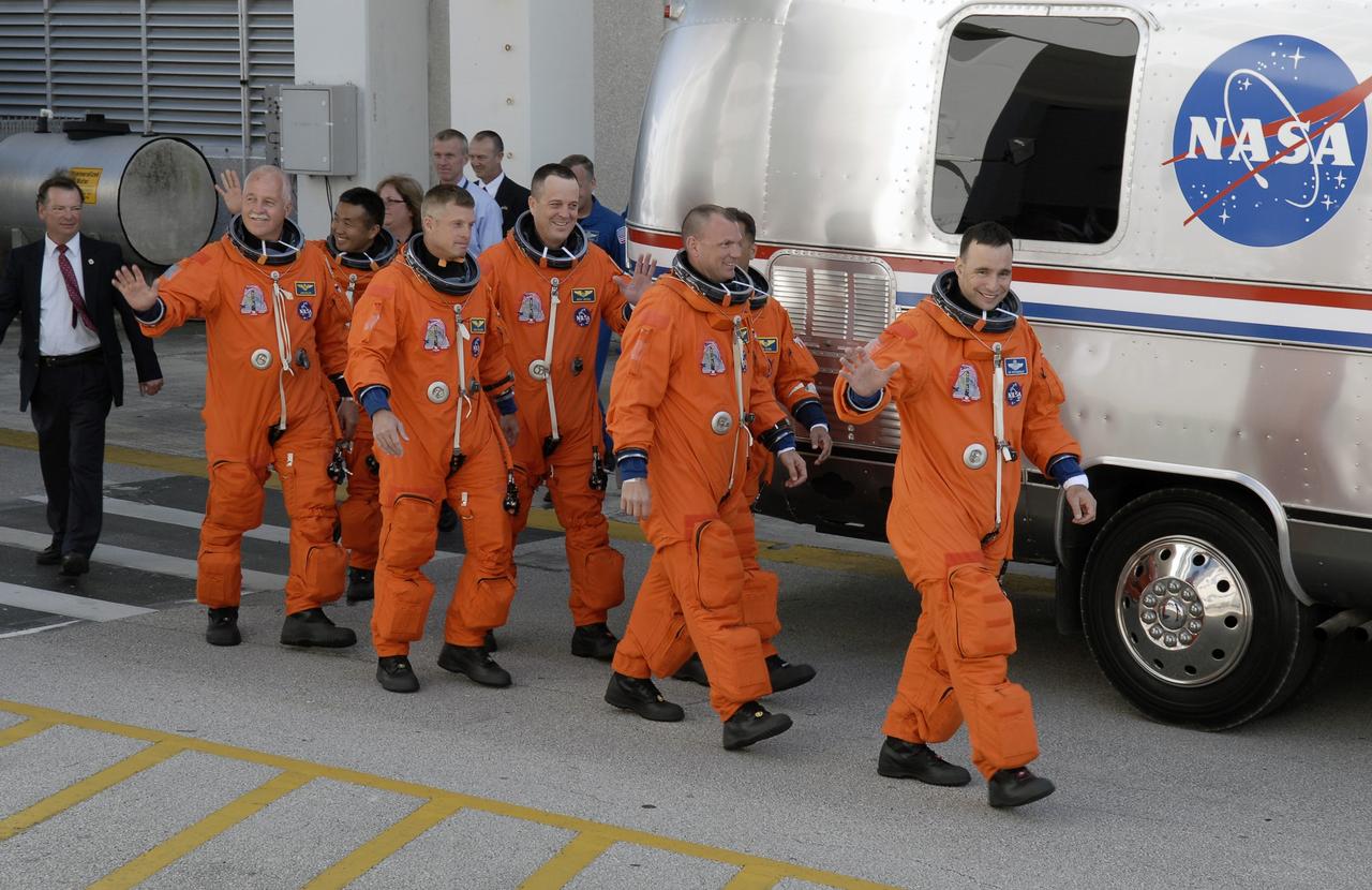 CAPE CANAVERAL, Fla. – The STS-119 crew members head for the Astrovan to take them to Launch Pad 39A at NASA's Kennedy Space Center in Florida for launch of space shuttle Discovery to the International Space Station.  From left are Mission Specialists John Phillips, Koichi Wakata, Steve Swanson and Richard Arnold, Pilot Tony Antonelli, Mission Specialist Joseph Acaba (behind Antonelli) and Commander Lee Archambault. Wakata represents the Japan Aerospace Exploration Agency and will remain on the International Space Station, replacing Expedition 18 Flight Engineer Sandra Magnus, who returns to Earth with the STS-119 crew.  Liftoff of Discovery is scheduled for 7:43 p.m. EDT on March 15. An earlier launch attempt March 11 was scrubbed at 2:36 p.m. due to a gaseous hydrogen leak from the external tank at the Ground Umbilical Carrier Plate during tanking. A seven-inch quick disconnect and two seals were replaced. The STS-119 mission is the 28th to the space station and the 125th space shuttle flight.  Discovery will deliver the final pair of power-generating solar array wings and the S6 truss segment.  Installation of S6 will signal the station's readiness to house a six-member crew for conducting increased science.  Photo credit: NASA/Kim Shiflett