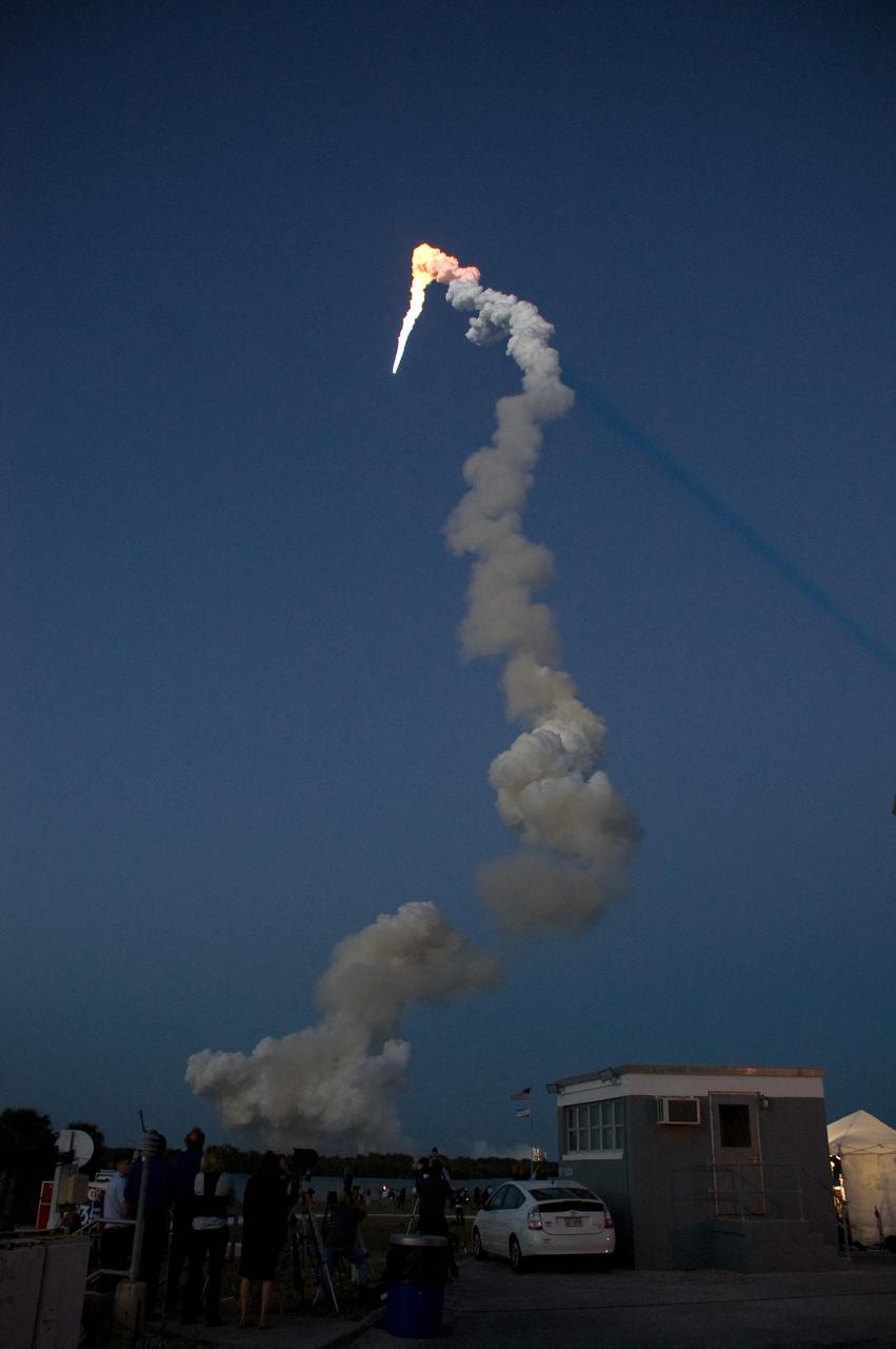 CAPE CANAVERAL, Fla. – As it arcs into space, space shuttle Discovery is lighted by sunlight after leaving the darker skies over NASA's Kennedy Space Center in Florida on the STS-119 mission.  Liftoff was on time at 7:43 p.m. EDT.  The STS-119 mission is the 28th to the International Space Station and the 125th space shuttle flight.  Discovery will deliver the final pair of power-generating solar array wings and the S6 truss segment.  Installation of S6 will signal the station's readiness to house a six-member crew for conducting increased science.  Photo credit: NASA/Fletch Hildreth