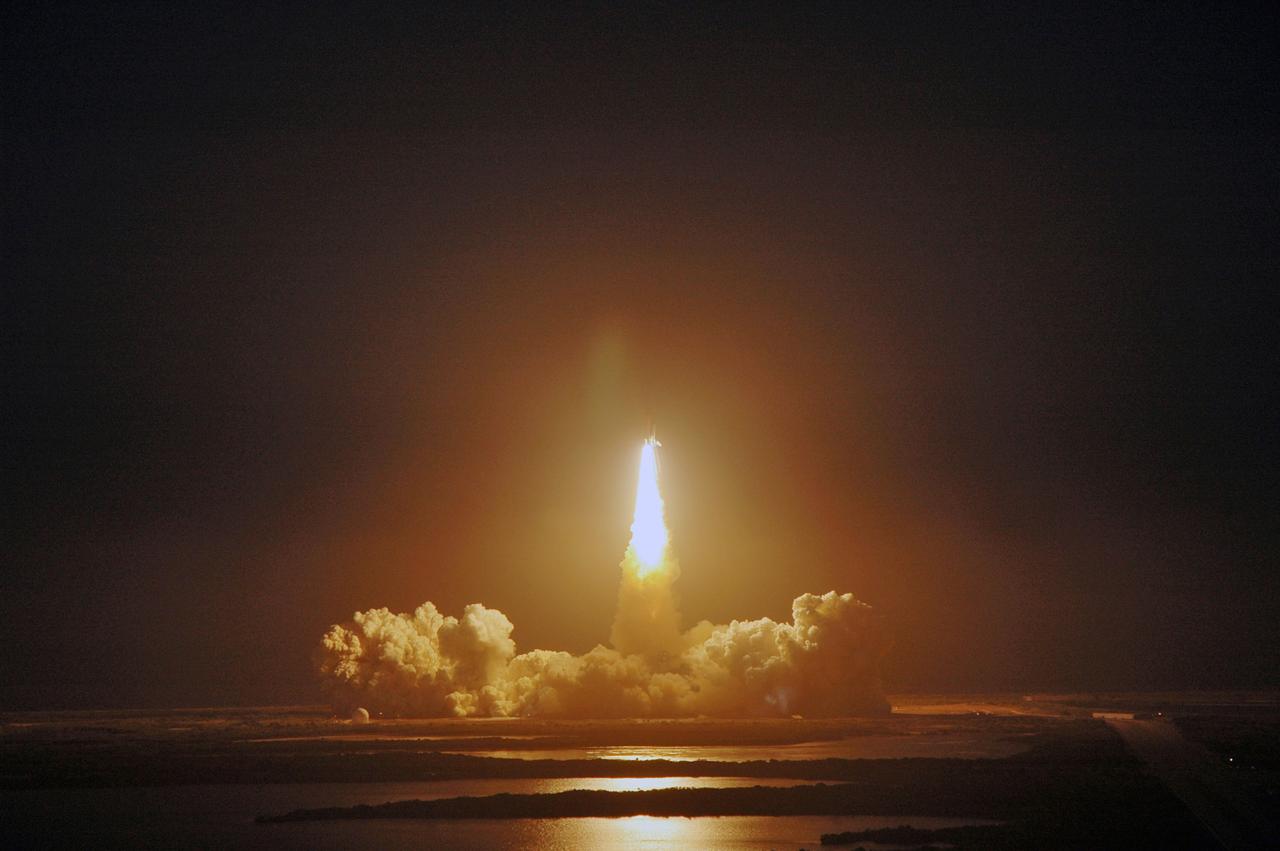 CAPE CANAVERAL, Fla. – Viewed from the roof of the Vehicle Assembly Building at NASA's Kennedy Space Center in Florida, space shuttle Discovery rides the tower of flames as it roars into space on the STS-119 mission.  Liftoff was on time at 7:43 p.m. EDT. The STS-119 mission is the 28th to the International Space Station and the 125th space shuttle flight.  Discovery will deliver the final pair of power-generating solar array wings and the S6 truss segment.  Installation of S6 will signal the station's readiness to house a six-member crew for conducting increased science. Photo credit: NASA/Marino Jeffrey