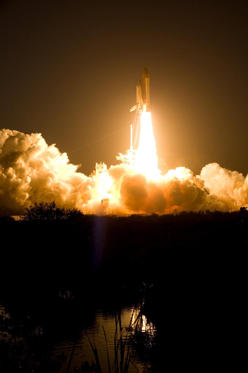 CAPE CANAVERAL, Fla. – Brilliant flames ignite the sky over Launch Pad 39A at NASA's Kennedy Space Center in Florida as space shuttle Discovery roars toward space on the STS-119 mission. Liftoff was on time at 7:43 p.m. EDT. The STS-119 mission is the 28th to the International Space Station and the 125th space shuttle flight.  Discovery will deliver the final pair of power-generating solar array wings and the S6 truss segment.  Installation of S6 will signal the station's readiness to house a six-member crew for conducting increased science. Photo credit: NASA/Sandra Joseph, Kevin O'Connell