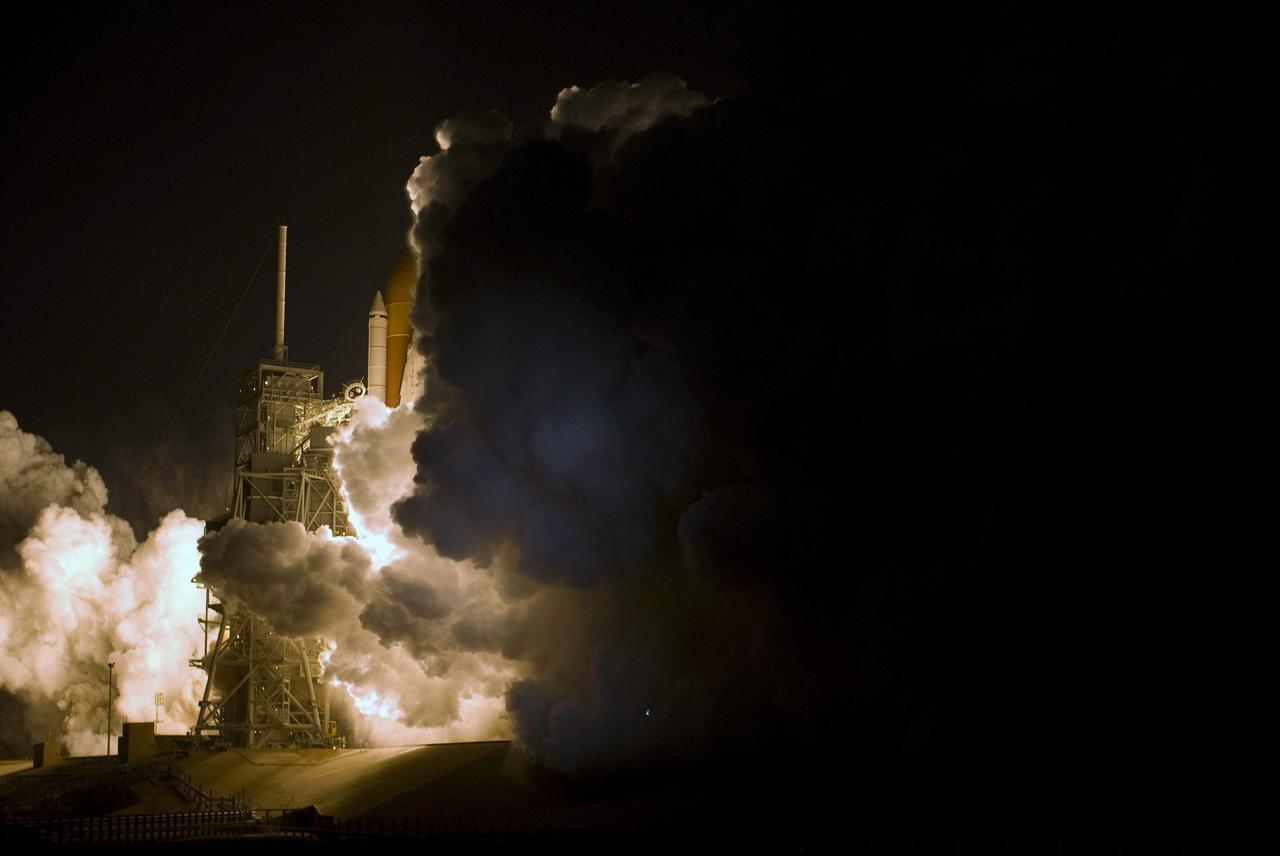 CAPE CANAVERAL, Fla. – Light and dark clouds of smoke and steam, spawned by the fire of liftoff, roll across Launch Pad 39A at NASA's Kennedy Space Center in Florida as space shuttle Discovery heads to space on the STS-119 mission.  Liftoff was on time at 7:43 p.m. EDT. The STS-119 mission is the 28th to the International Space Station and the 125th space shuttle flight.  Discovery will deliver the final pair of power-generating solar array wings and the S6 truss segment.  Installation of S6 will signal the station's readiness to house a six-member crew for conducting increased science. Photo credit: NASA/Tony Gray, Tom Farrar