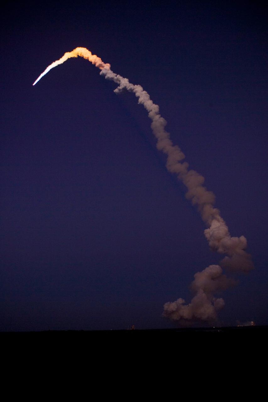 CAPE CANAVERAL, Fla. – As it arcs into space, space shuttle Discovery is lighted by sunlight after leaving the darker skies over NASA's Kennedy Space Center in Florida on the STS-119 mission.  Liftoff was on time at 7:43 p.m. EDT. The STS-119 mission is the 28th to the International Space Station and the 125th space shuttle flight.  Discovery will deliver the final pair of power-generating solar array wings and the S6 truss segment.  Installation of S6 will signal the station's readiness to house a six-member crew for conducting increased science. Photo credit: NASA/Jeff Wolfe