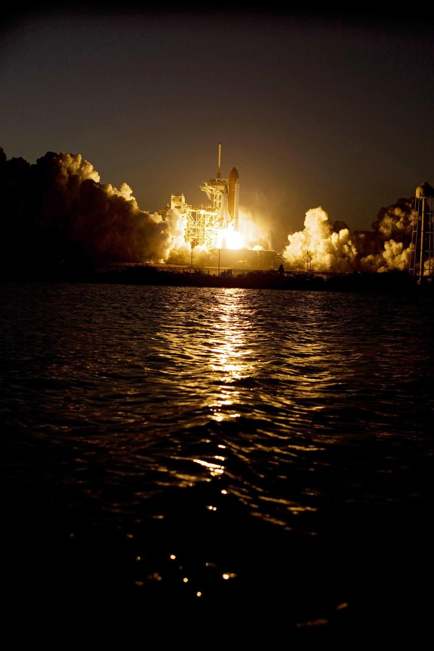 CAPE CANAVERAL, Fla. – Clouds of smoke and steam billow across Launch Pad 39A at NASA's Kennedy Space Center in Florida as space shuttle Discovery roars into the evening sky.  Liftoff was on time at 7:43 p.m. EDT. The STS-119 mission is the 28th to the International Space Station and the 125th space shuttle flight.  Discovery will deliver the final pair of power-generating solar array wings and the S6 truss segment.  Installation of S6 will signal the station's readiness to house a six-member crew for conducting increased science.  Photo credit: NASA/Tony Gray, Tom Farrar