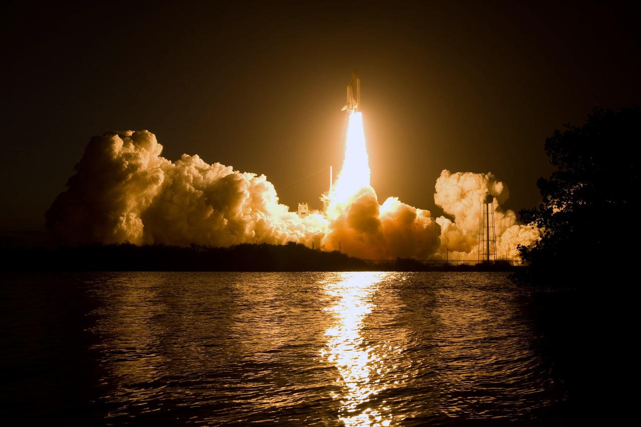 CAPE CANAVERAL, Fla. – Billows of smoke and the water near Launch Pad 39A at NASA's Kennedy Space Center in Florida capture the brilliant light of space shuttle Discovery's lift-off on the STS-119 mission.  The launch was on time at 7:43 p.m. EDT. The STS-119 mission is the 28th to the International Space Station and the 125th space shuttle flight.  Discovery will deliver the final pair of power-generating solar array wings and the S6 truss segment.  Installation of S6 will signal the station's readiness to house a six-member crew for conducting increased science. Photo credit: NASA/Sandra Joseph, Kevin O'Connell