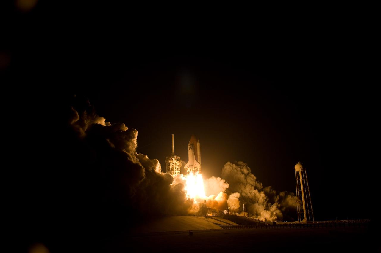 CAPE CANAVERAL, Fla. – Clouds of smoke and steam roll across Launch Pad 39A at NASA's Kennedy Space Center in Florida as space shuttle Discovery roars into the night sky on the STS-119 mission.  The launch was on time at 7:43 p.m. EDT. The STS-119 mission is the 28th to the International Space Station and the 125th space shuttle flight.  Discovery will deliver the final pair of power-generating solar array wings and the S6 truss segment.  Installation of S6 will signal the station's readiness to house a six-member crew for conducting increased science.  Photo credit: NASA/Sandra Joseph, Kevin O'Connell