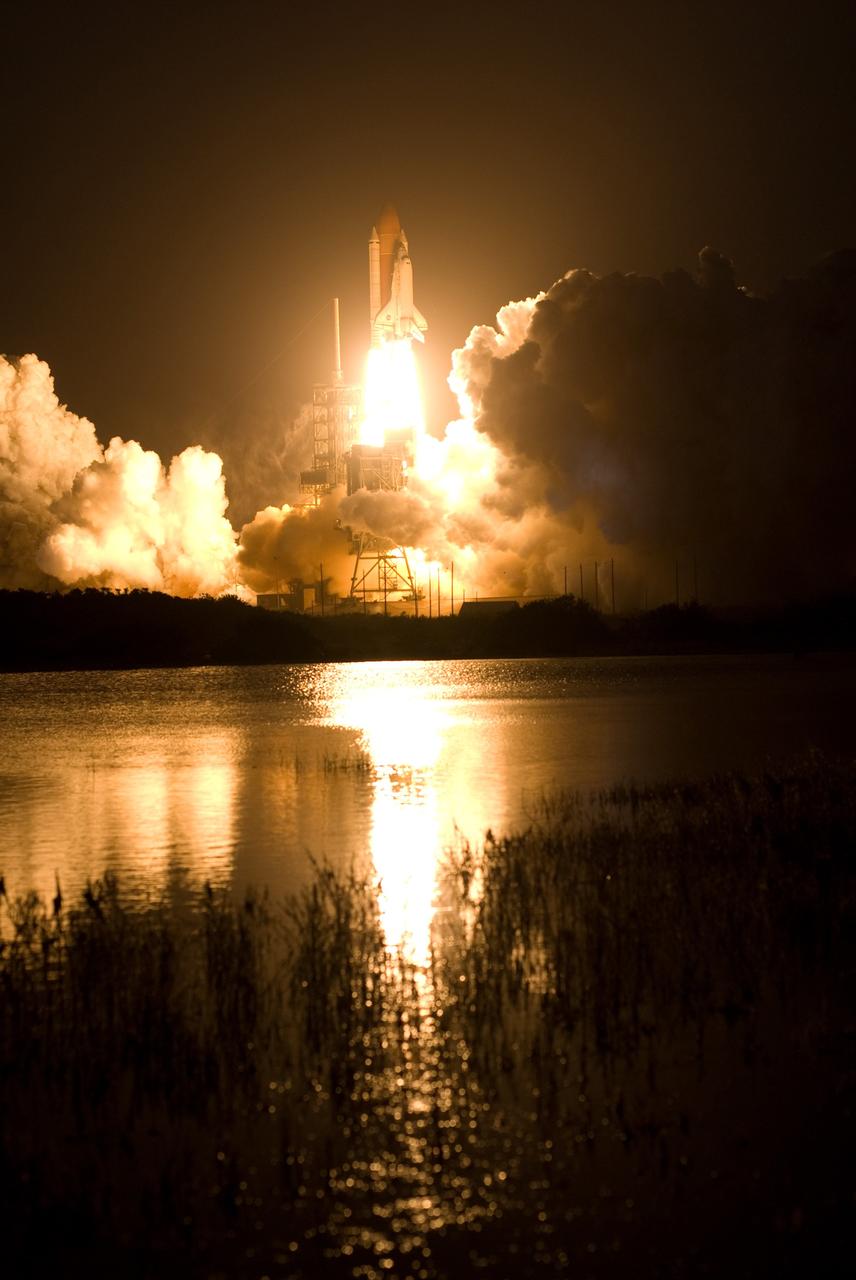 CAPE CANAVERAL, Fla. – The brilliant light of space shuttle Discovery's lift-off on the STS-119 mission lights up the clouds of smoke and the water near Launch Pad 39A at NASA's Kennedy Space Center in Florida. The launch was on time at 7:43 p.m. EDT. The STS-119 mission is the 28th to the International Space Station and the 125th space shuttle flight.  Discovery will deliver the final pair of power-generating solar array wings and the S6 truss segment.  Installation of S6 will signal the station's readiness to house a six-member crew for conducting increased science.  Photo credit: NASA/Tony Gray, Tom Farrar