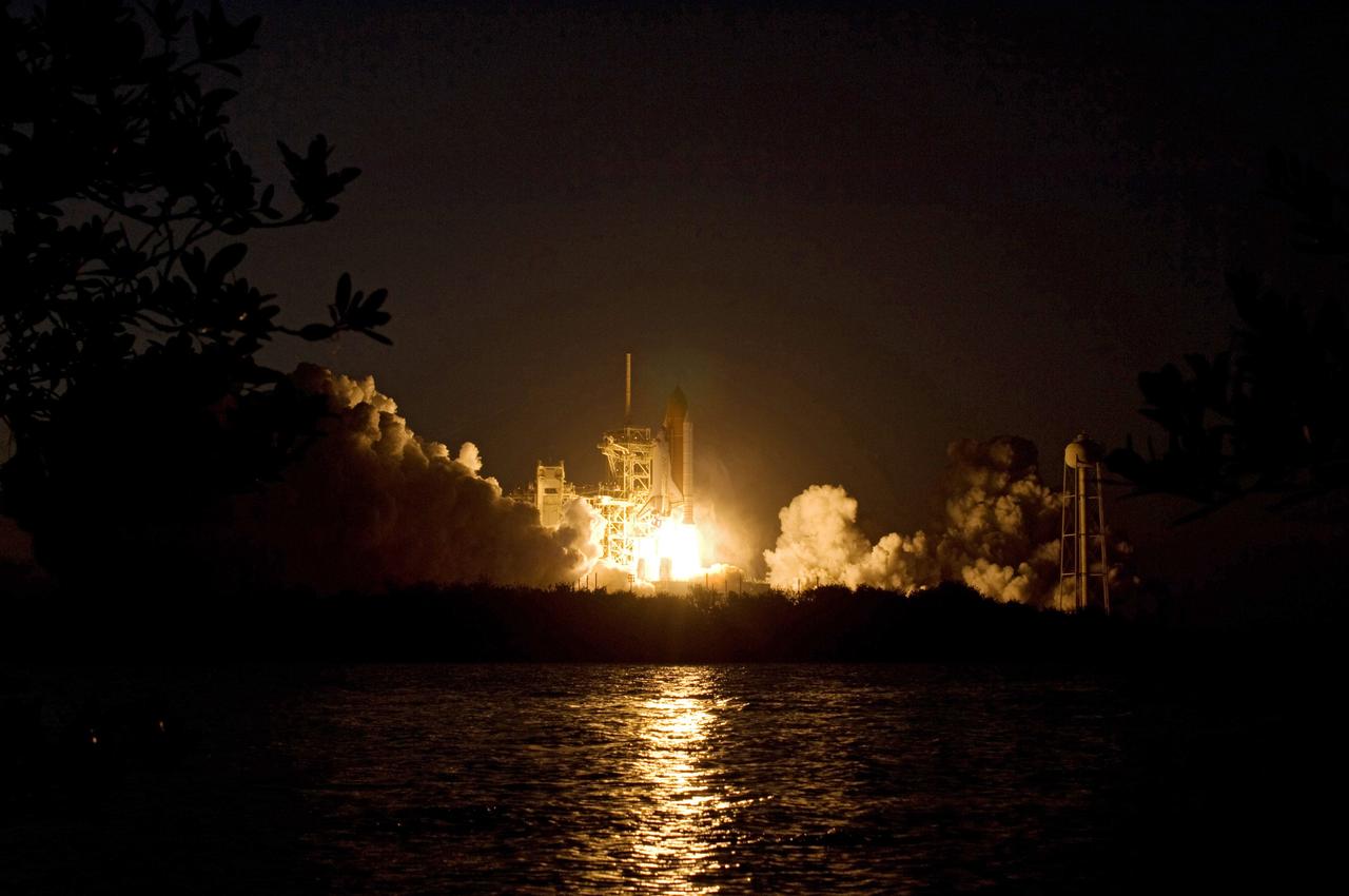CAPE CANAVERAL, Fla. – The brilliant light of space shuttle Discovery's lift-off on the STS-119 mission lights up the clouds of smoke and the water near Launch Pad 39A at NASA's Kennedy Space Center in Florida. The launch was on time at 7:43 p.m. EDT. The STS-119 mission is the 28th to the International Space Station and the 125th space shuttle flight.  Discovery will deliver the final pair of power-generating solar array wings and the S6 truss segment.  Installation of S6 will signal the station's readiness to house a six-member crew for conducting increased science.  Photo credit: NASA/Sandra Joseph, Kevin O'Connell
