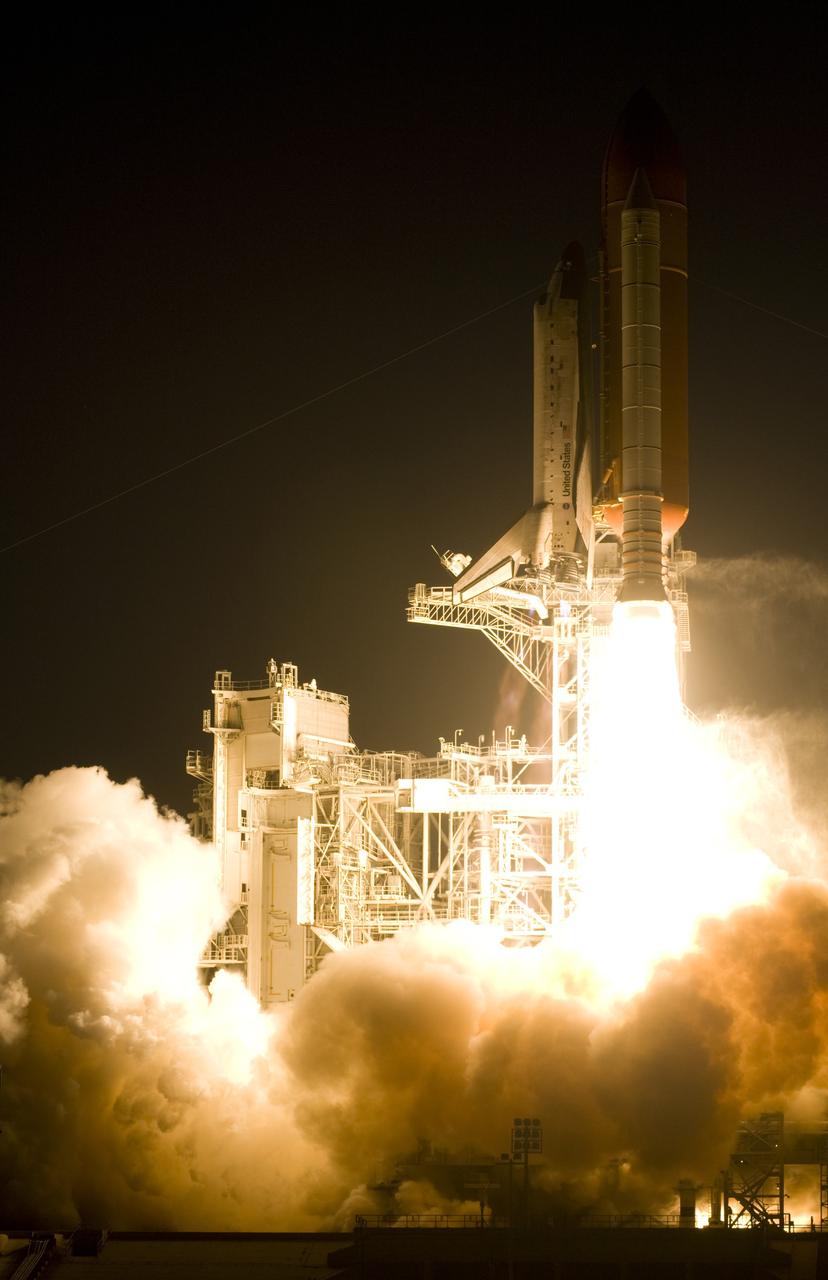 CAPE CANAVERAL, Fla. – Propelled by a column of fire, space shuttle Discovery races toward space on the STS-119 mission after liftoff from Launch Pad 39A at NASA's Kennedy Space Center in Florida. Clouds of smoke and steam roll across the pad.  Launch was on time at 7:43 p.m. EDT. The STS-119 mission is the 28th to the International Space Station and the 125th space shuttle flight.  Discovery will deliver the final pair of power-generating solar array wings and the S6 truss segment.  Installation of S6 will signal the station's readiness to house a six-member crew for conducting increased science.  Photo courtesy of Scott Andrews