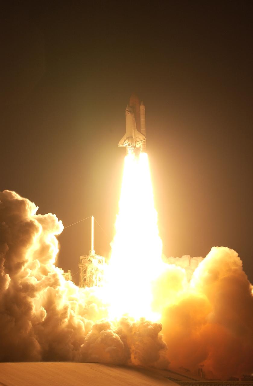 CAPE CANAVERAL, Fla. – Propelled by columns of fire, space shuttle Discovery races toward space on the STS-119 mission after liftoff from Launch Pad 39A at NASA's Kennedy Space Center in Florida. Clouds of smoke and steam roll across the pad.  Launch was on time at 7:43 p.m. EDT. The STS-119 mission is the 28th to the International Space Station and the 125th space shuttle flight.  Discovery will deliver the final pair of power-generating solar array wings and the S6 truss segment.  Installation of S6 will signal the station's readiness to house a six-member crew for conducting increased science.  Photo credit: NASA/Sandra Joseph, Kevin O'Connell