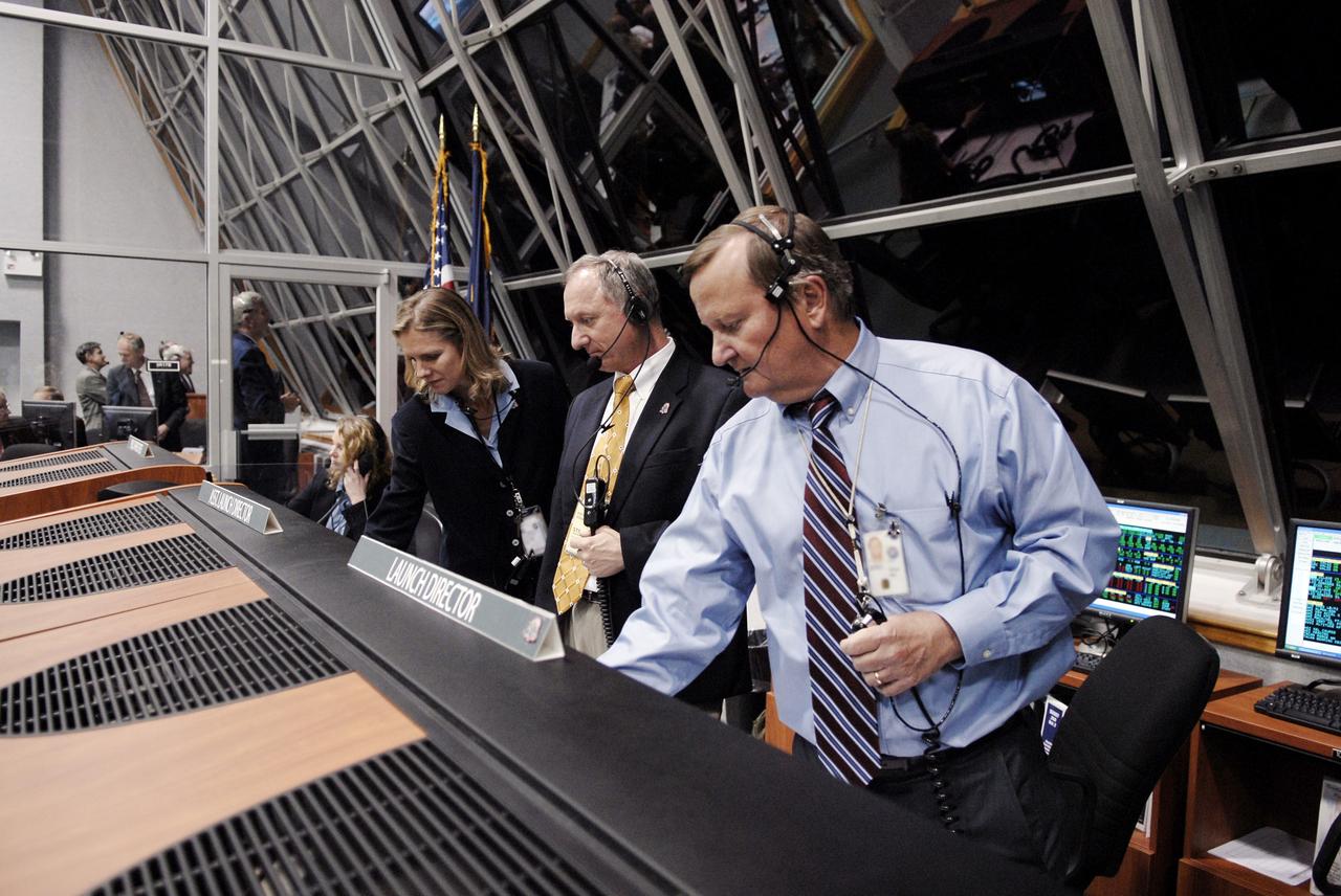 CAPE CANAVERAL, Fla. – In Firing Room 4 of the Launch Control Center at NASA's Kennedy Space Center in Florida, Flow Director for space shuttle Discovery Stephanie Stilson, Assistant Launch Director Pete Nickolenko and Shuttle Launch Director Mike Leinbach check the computers for follow-up images of the launch of space shuttle Discovery on the STS-119 mission.   Launch was on time at 7:43 p.m. EDT. The STS-119 mission is the 28th to the space station and Discovery's 36th flight.  Discovery will deliver the final pair of power-generating solar array wings and the S6 truss segment.  Installation of S6 will signal the station's readiness to house a six-member crew for conducting increased science.  Photo credit: NASA/Kim Shiflett