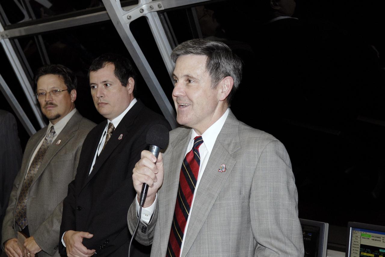 CAPE CANAVERAL, Fla. – In Firing Room 4 of the Launch Control Center at NASA's Kennedy Space Center in Florida, Center Director Bob Cabana (with microphone) congratulates the mission management team after the successful launch of space shuttle Discovery on the STS-119 mission.  Launch was on time at 7:43 p.m. EDT. The STS-119 mission is the 28th to the space station and Discovery's 36th flight.  Discovery will deliver the final pair of power-generating solar array wings and the S6 truss segment.  Installation of S6 will signal the station's readiness to house a six-member crew for conducting increased science.  Photo credit: NASA/Kim Shiflett