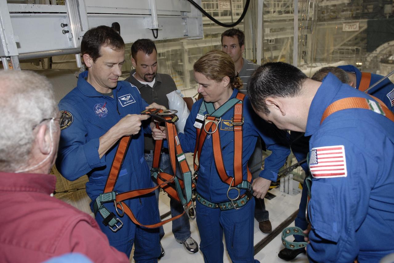 CAPE CANAVERAL, Fla. – In the Orbiter Processing Facility at NASA's Kennedy Space Center in Florida, astronauts Tom Marshburn and Julie Payette put on their safety harnesses before taking a close look at space shuttle Endeavour. Both are mission specialists on the STS-127 mission to the International Space Station. The crew members are at Kennedy for a crew equipment interface test, which provides hands-on training and observation of shuttle and flight hardware. Endeavour will deliver the Japanese Experiment Module's Experiment Logistics Module-Exposed Section, or ELM-ES, to the space station on STS-127. Launch is targeted for mid-June, 2009. Photo credit: NASA/Kim Shiflett