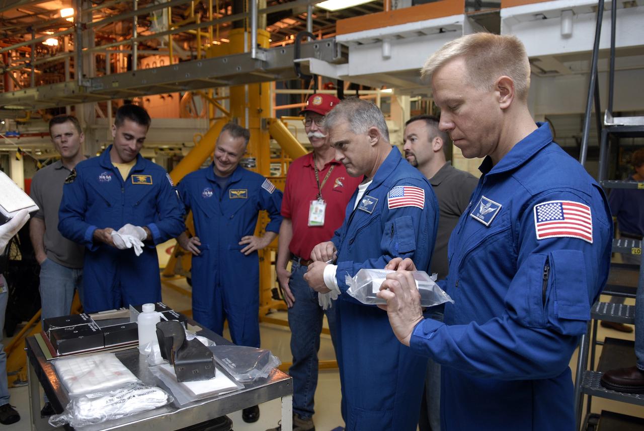 CAPE CANAVERAL, Fla. – In the Orbiter Processing Facility at NASA's Kennedy Space Center in Florida, astronauts (from left) Christopher Cassidy, Doug Hurley, Dave Wolf and Tim Kopra look at equipment they will use on the STS-127 mission to the International Space Station. Hurley is the pilot and Cassidy, Wolf and Kopra are mission specialists. Kopra will remain on the station as part of the Expedition 19 crew. The crew members are at Kennedy for a crew equipment interface test, which provides hands-on training and observation of shuttle and flight hardware. Endeavour will deliver the Japanese Experiment Module's Experiment Logistics Module-Exposed Section, or ELM-ES, to the space station on STS-127. Launch is targeted for mid-June, 2009. Photo credit: NASA/Kim Shiflett