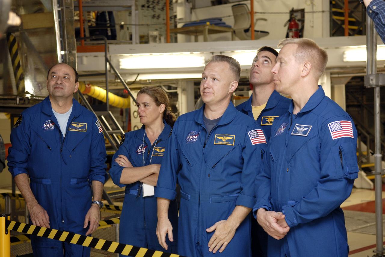 CAPE CANAVERAL, Fla. – In the Orbiter Processing Facility at NASA's Kennedy Space Center in Florida, astronauts with the STS-127 mission look at equipment that will be used on the mission to the International Space Station. From left are Commander Mark Polansky, Mission Specialist Julie Payette, Pilot Doug Hurley, Mission Specialists Chris Cassidy and Tim Kopra. Kopra will join the Expedition 19 crew on the station. The crew members are at Kennedy for a crew equipment interface test, which provides hands-on training and observation of shuttle and flight hardware. Endeavour will deliver the Japanese Experiment Module's Experiment Logistics Module-Exposed Section, or ELM-ES, to the space station on STS-127. Launch is targeted for mid-June, 2009. Photo credit: NASA/Kim Shiflett