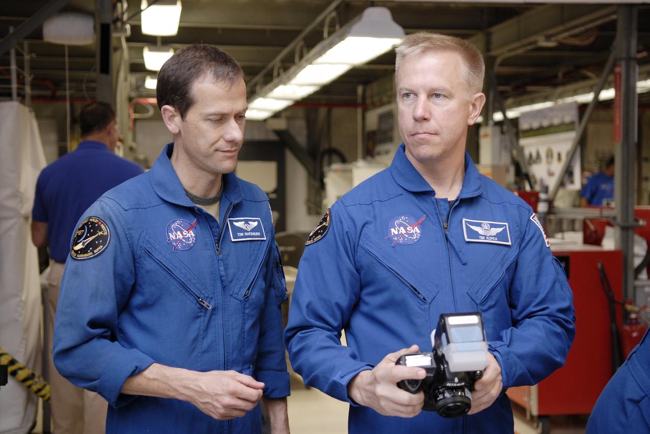 CAPE CANAVERAL, Fla. – In the Orbiter Processing Facility at NASA's Kennedy Space Center in Florida, astronauts with the STS-127 mission handle the camera they will use on the mission to the International Space Station. At left is Mission Specialist Tom Marshburn; at right is Mission Specialist Tim Kopra, who will remain with the Expedition 19 crew on the station. The crew members are at Kennedy for a crew equipment interface test, which provides hands-on training and observation of shuttle and flight hardware. Endeavour will deliver the Japanese Experiment Module's Experiment Logistics Module-Exposed Section, or ELM-ES, to the space station on STS-127. Launch is targeted for mid-June, 2009. Photo credit: NASA/Kim Shiflett