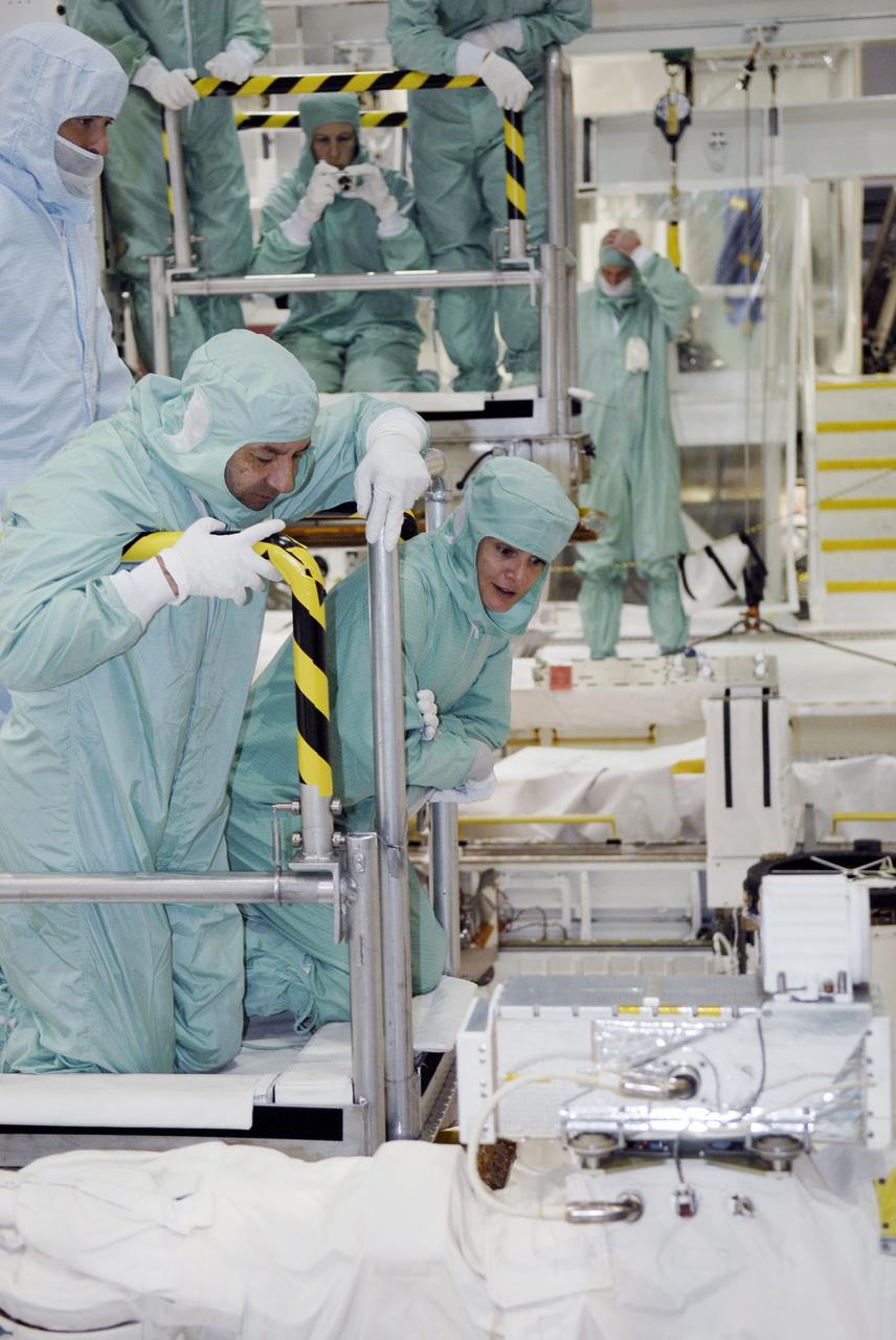 CAPE CANAVERAL, Fla. – In the Orbiter Processing Facility at NASA's Kennedy Space Center in Florida, STS-127 crew members are lowered into space shuttle Endeavour's payload bay for a close look at installed hardware. In the foreground are Commander Mark Polansky and Mission Specialist Julie Payette. The crew members are at Kennedy for a crew equipment interface test, which provides hands-on training and observation of shuttle and flight hardware. Endeavour will deliver the Japanese Experiment Module's Experiment Logistics Module-Exposed Section, or ELM-ES, to the International Space Station on STS-127. Launch is targeted for mid-June, 2009. Photo credit: NASA/Kim Shiflett