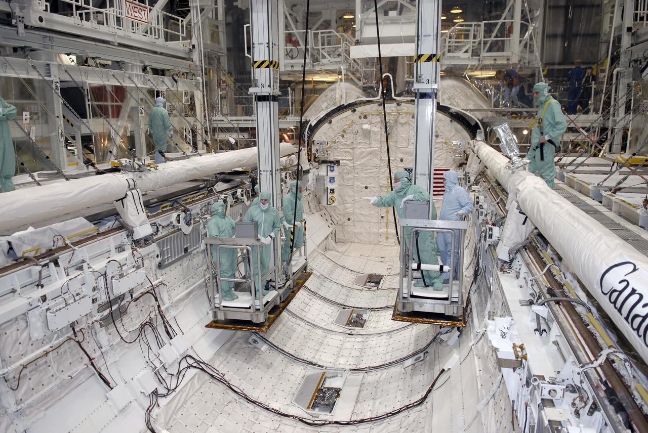 CAPE CANAVERAL, Fla. – In the Orbiter Processing Facility at NASA's Kennedy Space Center in Florida, STS-127 crew members are lowered inside space shuttle Endeavour's payload bay for a close look at installed hardware. The crew members are at Kennedy for a crew equipment interface test, which provides hands-on training and observation of shuttle and flight hardware. Endeavour will deliver the Japanese Experiment Module's Experiment Logistics Module-Exposed Section, or ELM-ES, to the International Space Station on STS-127. Launch is targeted for mid-June, 2009. Photo credit: NASA/Kim Shiflett