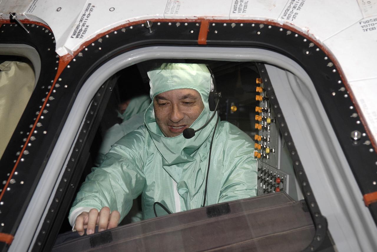 CAPE CANAVERAL, Fla. – In the Orbiter Processing Facility at NASA's Kennedy Space Center in Florida, STS-127 Commander Mark Polansky checks the cockpit of space shuttle Endeavour.    The crew members are at Kennedy for a crew equipment interface test, which provides hands-on training and observation of shuttle and flight hardware.  Endeavour will deliver the Japanese Experiment Module's Experiment Logistics Module-Exposed Section, or ELM-ES, to the International Space Station on STS-127.  Launch is targeted for mid-June, 2009.  Photo credit: NASA/Kim Shiflett