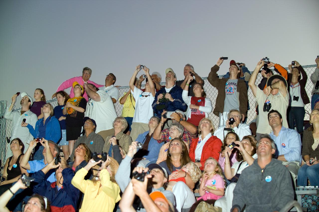 CAPE CANAVERAL, Fla. – Spectators at the Banana River Viewing Site at NASA's Kennedy Space Center in Florida focus on the brilliant launch of space shuttle Discovery across the water. Liftoff from Launch Pad 39A was on time at 7:43 p.m. EDT. The STS-119 mission is the 28th to the space station and Discovery's 36th flight. Discovery will deliver the final pair of power-generating solar array wings and the S6 truss segment. Installation of S6 will signal the station's readiness to house a six-member crew for conducting increased science. Photo credit: NASA/Chris Lynch