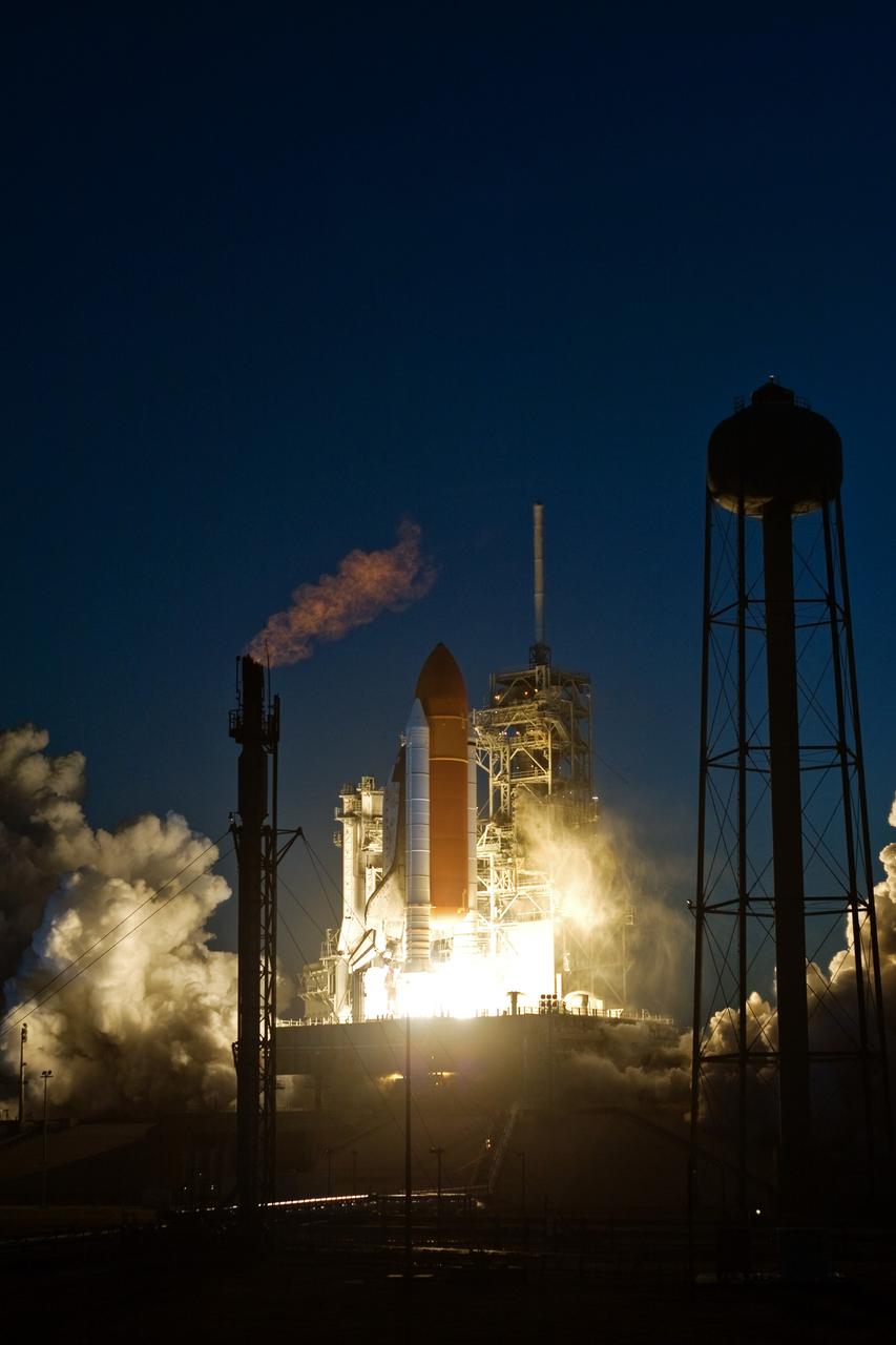 CAPE CANAVERAL, Fla. – On Launch Pad 39A at NASA's Kennedy Space Center in Florida, the fiery exhaust from liftoff of space shuttle Discovery lights up the evening sky.  Launch on mission STS-119 was on time at 7:43 p.m. EDT.  The STS-119 mission is the 28th to the space station and Discovery's 36th flight.  Discovery will deliver the final pair of power-generating solar array wings and the S6 truss segment.  Installation of S6 will signal the station's readiness to house a six-member crew for conducting increased science.  Photo credit: NASA/Tony Gray, Tom Farrar