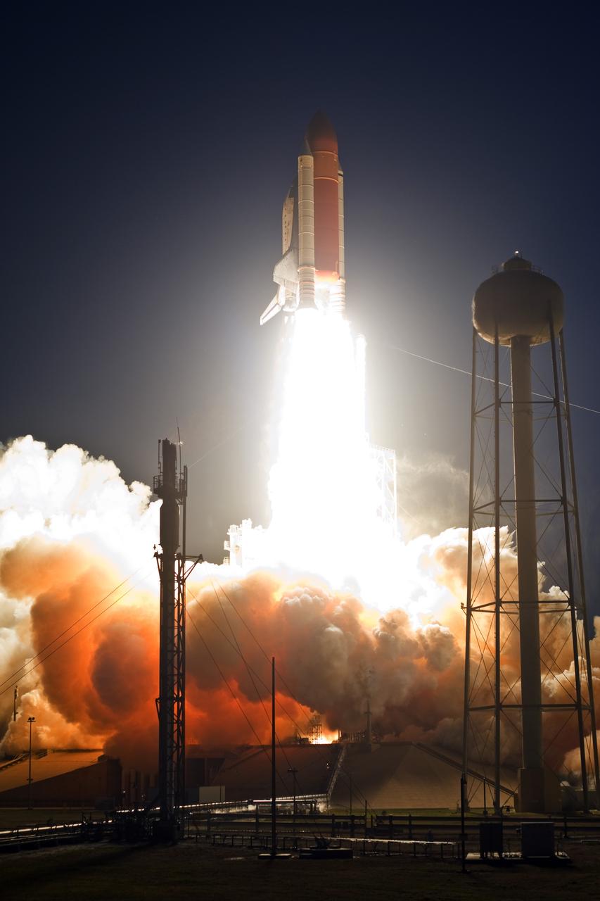 CAPE CANAVERAL, Fla. – From Launch Pad 39A at NASA's Kennedy Space Center in Florida, space shuttle Discovery races toward space atop towers of flame.  Clouds of smoke and steam engulf the pad below.  Launch on mission STS-119 was on time at 7:43 p.m. EDT. The STS-119 mission is the 28th to the space station and Discovery's 36th flight.  Discovery will deliver the final pair of power-generating solar array wings and the S6 truss segment.  Installation of S6 will signal the station's readiness to house a six-member crew for conducting increased science.  Photo credit: NASA/Tony Gray, Tom Farrar