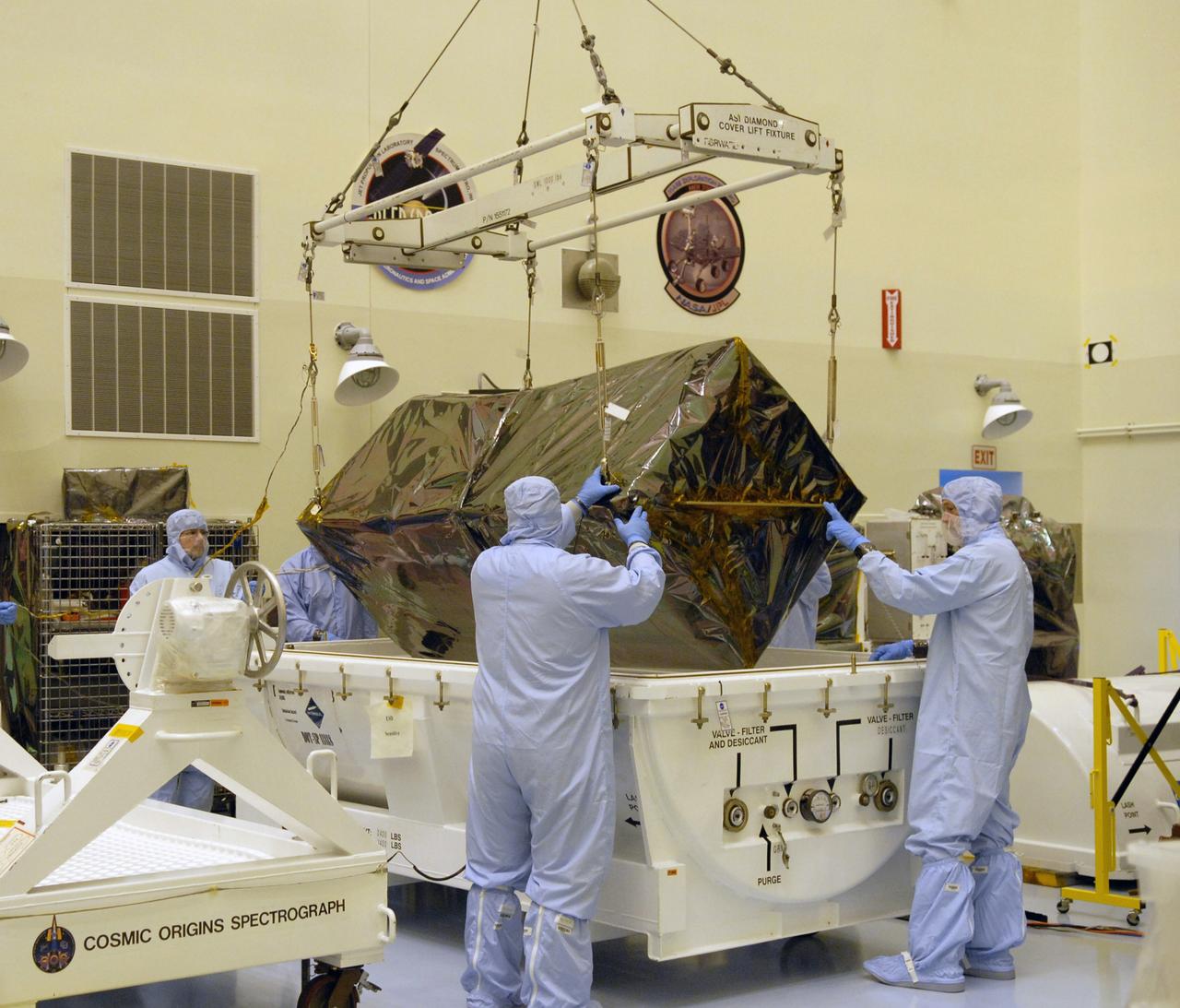 CAPE CANAVERAL, Fla. – In the Payload Hazardous Servicing Facility at NASA's Kennedy Space Center in Florida, under the guidance of the technicians, a crane lifts the Cosmic Origins Spectrograph, or COS, from the shipping container. The COS, part of the payload on space shuttle Atlantis for the Hubble servicing mission, targeted to launch in mid-May, is being moved to a test stand. Installing the COS during the mission will effectively restore spectroscopy to Hubble’s scientific arsenal, and at the same time provide the telescope with unique capabilities. COS is designed to study the large-scale structure of the universe and how galaxies, stars and planets formed and evolved. It will help determine how elements needed for life such as carbon and iron first formed and how their abundances have increased over the lifetime of the universe. Photo credit: NASA/Jack Pfaller