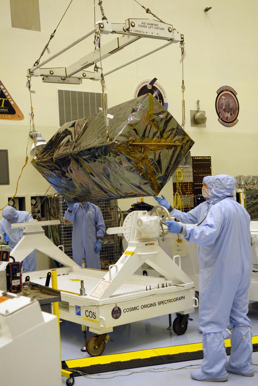 CAPE CANAVERAL, Fla. – In the Payload Hazardous Servicing Facility at NASA's Kennedy Space Center in Florida, under the guidance of the technicians, a crane lowers the Cosmic Origins Spectrograph, or COS, onto a test stand. The COS is part of the payload on space shuttle Atlantis for the Hubble servicing mission, targeted to launch in mid-May. Installing the COS during the mission will effectively restore spectroscopy to Hubble’s scientific arsenal, and at the same time provide the telescope with unique capabilities. COS is designed to study the large-scale structure of the universe and how galaxies, stars and planets formed and evolved. It will help determine how elements needed for life such as carbon and iron first formed and how their abundances have increased over the lifetime of the universe. Photo credit: NASA/Jack Pfaller