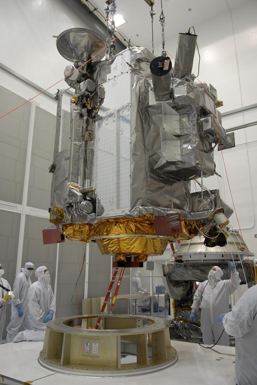 CAPE CANAVERAL, Fla. – At the Astrotech facility in Titusville, Fla., a crane moves NASA's Lunar Reconnaissance Orbiter, or LRO, toward a stand in the foreground. The orbiter will carry seven instruments to provide scientists with detailed maps of the lunar surface and enhance our understanding of the moon's topography, lighting conditions, mineralogical composition and natural resources. Information gleaned from LRO will be used to select safe landing sites, determine locations for future lunar outposts and help mitigate radiation dangers to astronauts. The polar regions of the moon are the main focus of the mission because continuous access to sunlight may be possible and water ice may exist in permanently shadowed areas of the poles. Accompanying LRO on its journey to the moon will be the Lunar CRater Observation and Sensing Satellite, or LCROSS, a mission that will impact the lunar surface in its search for water ice. Launch of LRO is targeted for May 20.  Photo credit: NASA/Kim Shiflett