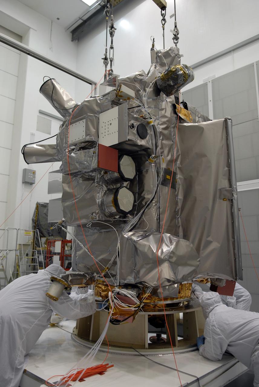 CAPE CANAVERAL, Fla. – At the Astrotech facility in Titusville, Fla., technicians secure NASA's Lunar Reconnaissance Orbiter, or LRO, onto a stand. The orbiter will carry seven instruments to provide scientists with detailed maps of the lunar surface and enhance our understanding of the moon's topography, lighting conditions, mineralogical composition and natural resources. Information gleaned from LRO will be used to select safe landing sites, determine locations for future lunar outposts and help mitigate radiation dangers to astronauts. The polar regions of the moon are the main focus of the mission because continuous access to sunlight may be possible and water ice may exist in permanently shadowed areas of the poles. Accompanying LRO on its journey to the moon will be the Lunar CRater Observation and Sensing Satellite, or LCROSS, a mission that will impact the lunar surface in its search for water ice. Launch of LRO is targeted for May 20.  Photo credit: NASA/Kim Shiflett