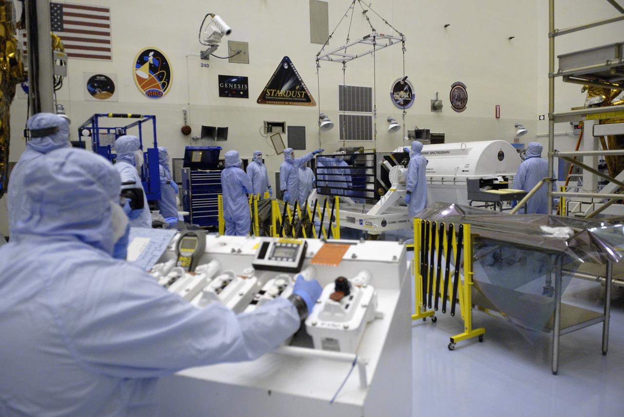 CAPE CANAVERAL, Fla. – In the Payload Hazardous Servicing Facility at NASA's Kennedy Space Center in Florida, technicians oversee the lifting of the Cosmic Origins Spectrograph, or COS, from a stand. The COS will be moved to and placed on the Orbital Replacement Unit Carrier that will be installed in space shuttle Atlantis' payload bay. The COS is part of the payload for the Hubble servicing mission, STS-125, targeted to launch in mid-May. Installing the COS during the mission will effectively restore spectroscopy to Hubble’s scientific arsenal, and at the same time provide the telescope with unique capabilities. COS is designed to study the large-scale structure of the universe and how galaxies, stars and planets formed and evolved. It will help determine how elements needed for life such as carbon and iron first formed and how their abundances have increased over the lifetime of the universe. Photo credit: NASA/Kim Shiflett