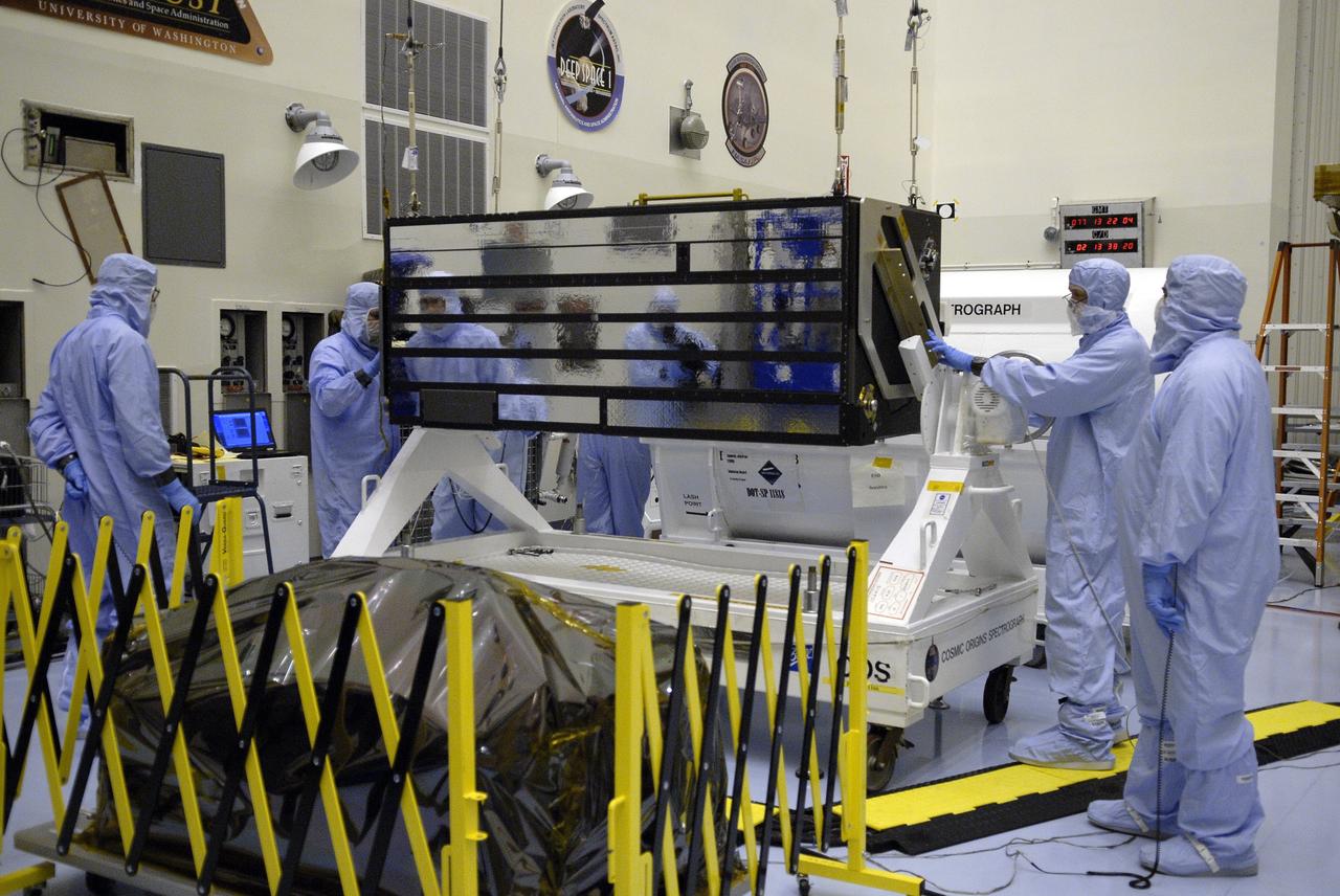 CAPE CANAVERAL, Fla. – In the Payload Hazardous Servicing Facility at NASA's Kennedy Space Center in Florida, technicians help with the lifting of the Cosmic Origins Spectrograph, or COS, from a stand. The COS will be moved to and placed on the Orbital Replacement Unit Carrier that will be installed in space shuttle Atlantis' payload bay. The COS is part of the payload for the Hubble servicing mission, STS-125, targeted to launch in mid-May. Installing the COS during the mission will effectively restore spectroscopy to Hubble’s scientific arsenal, and at the same time provide the telescope with unique capabilities. COS is designed to study the large-scale structure of the universe and how galaxies, stars and planets formed and evolved. It will help determine how elements needed for life such as carbon and iron first formed and how their abundances have increased over the lifetime of the universe. Photo credit: NASA/Kim Shiflett