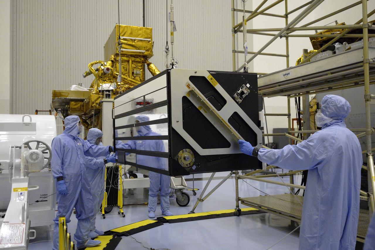 CAPE CANAVERAL, Fla. – In the Payload Hazardous Servicing Facility at NASA's Kennedy Space Center in Florida, technicians help guide the Cosmic Origins Spectrograph, or COS, as it is lifted from a stand. The COS will be moved to and placed on the Orbital Replacement Unit Carrier that will be installed in space shuttle Atlantis' payload bay. The COS is part of the payload for the Hubble servicing mission, STS-125, targeted to launch in mid-May. Installing the COS during the mission will effectively restore spectroscopy to Hubble’s scientific arsenal, and at the same time provide the telescope with unique capabilities. COS is designed to study the large-scale structure of the universe and how galaxies, stars and planets formed and evolved. It will help determine how elements needed for life such as carbon and iron first formed and how their abundances have increased over the lifetime of the universe. Photo credit: NASA/Kim Shiflett