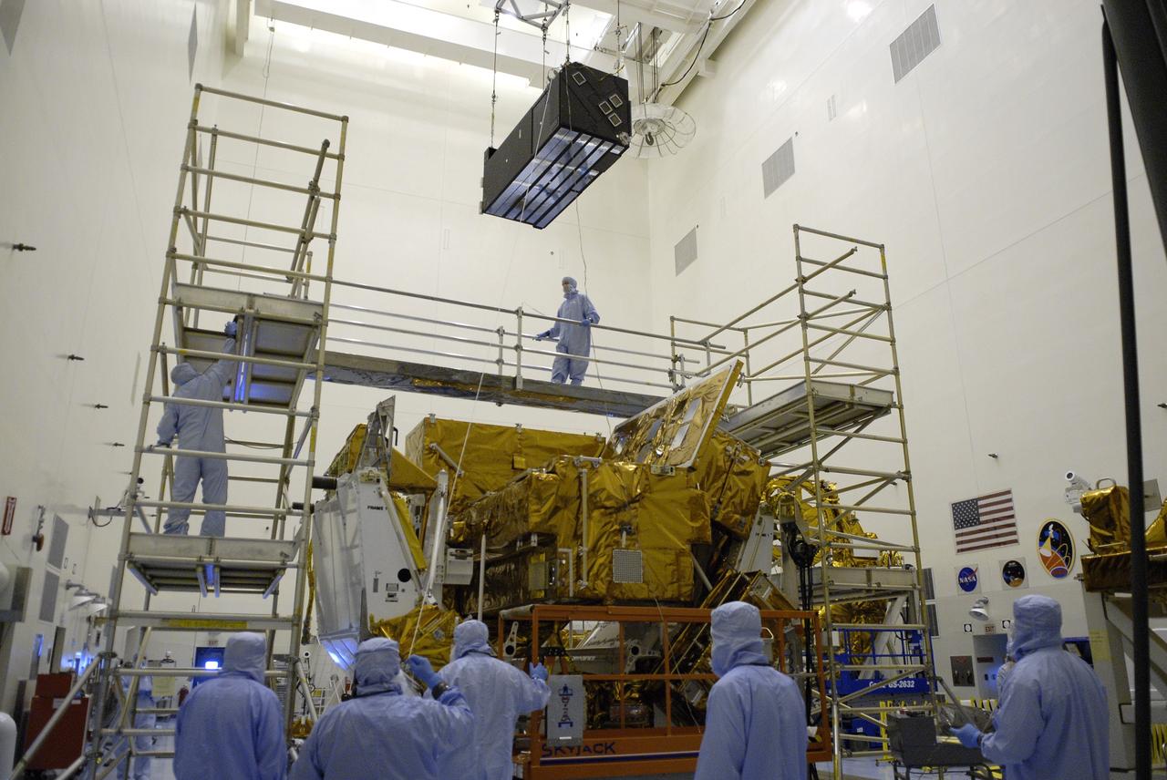 CAPE CANAVERAL, Fla. – In the Payload Hazardous Servicing Facility at NASA's Kennedy Space Center in Florida, a crane lowers the Cosmic Origins Spectrograph, or COS, toward the Orbital Replacement Unit Carrier where it will be installed. The carrier will be placed in space shuttle Atlantis' payload bay for the Hubble servicing mission, STS-125, targeted to launch in mid-May. Installing the COS during the mission will effectively restore spectroscopy to Hubble’s scientific arsenal, and at the same time provide the telescope with unique capabilities. COS is designed to study the large-scale structure of the universe and how galaxies, stars and planets formed and evolved. It will help determine how elements needed for life such as carbon and iron first formed and how their abundances have increased over the lifetime of the universe. Photo credit: NASA/Kim Shiflett