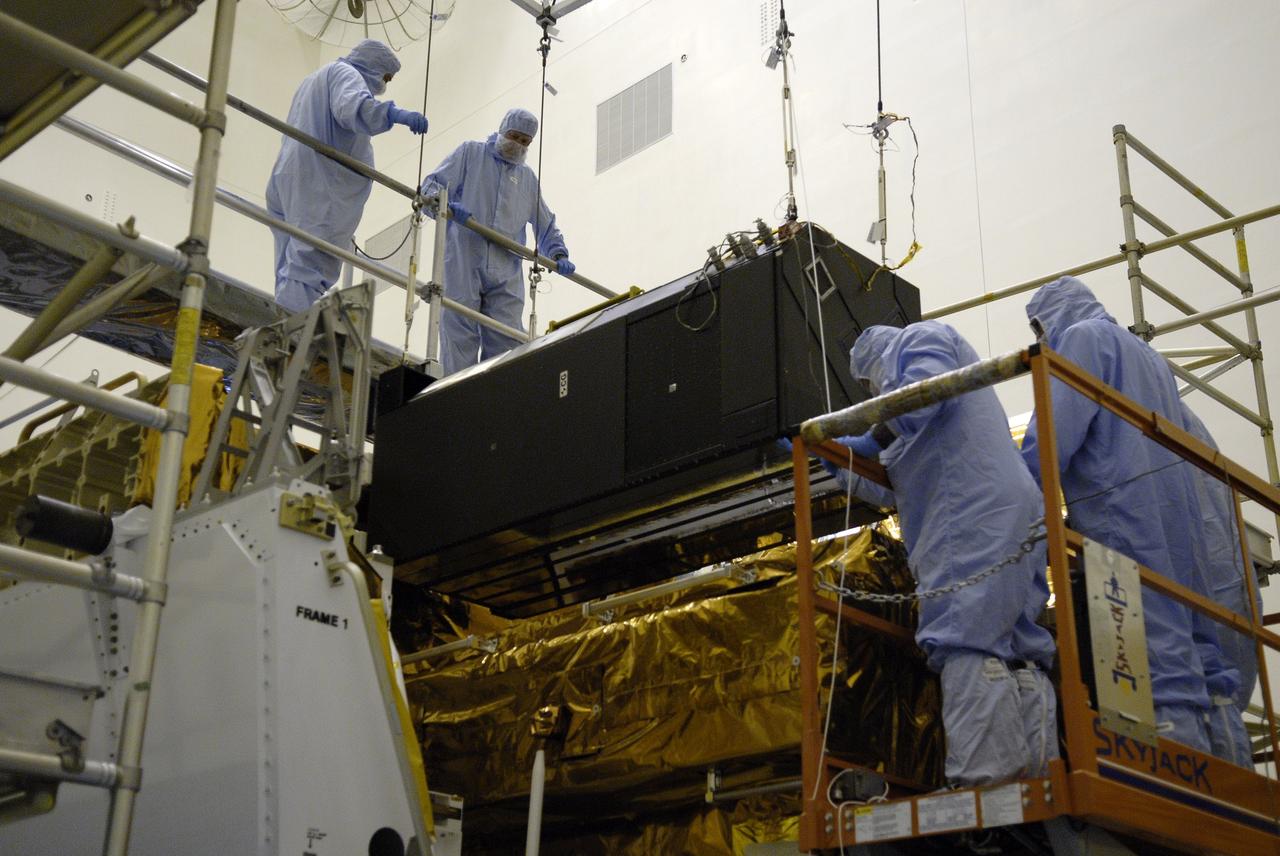 CAPE CANAVERAL, Fla. – In the Payload Hazardous Servicing Facility at NASA's Kennedy Space Center in Florida, a crane places the Cosmic Origins Spectrograph, or COS, on the Orbital Replacement Unit Carrier where it will be installed. The carrier will be placed in space shuttle Atlantis' payload bay for the Hubble servicing mission, STS-125, targeted to launch in mid-May. Installing the COS during the mission will effectively restore spectroscopy to Hubble’s scientific arsenal, and at the same time provide the telescope with unique capabilities. COS is designed to study the large-scale structure of the universe and how galaxies, stars and planets formed and evolved. It will help determine how elements needed for life such as carbon and iron first formed and how their abundances have increased over the lifetime of the universe. Photo credit: NASA/Kim Shiflett
