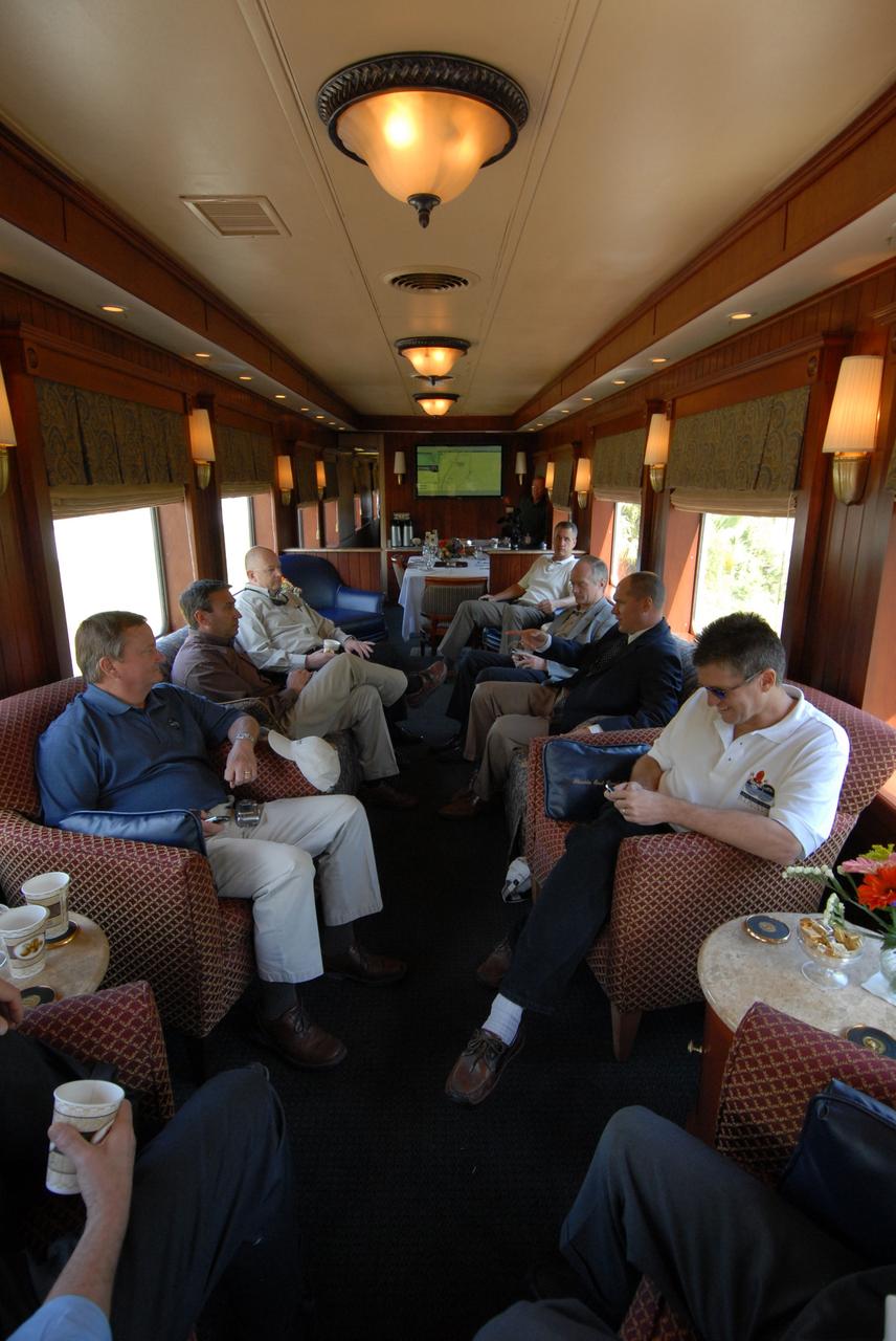 CAPE CANAVERAL, Fla. – ATK and NASA officials accompanied the Florida East Coast Railroad train carrying the booster segments for the Ares I-X test rocket on its route to NASA's Kennedy Space Center in Florida from Jacksonville, Fla.  Seen here in the passenger car are, from left NASA KSC Shuttle Launch Director Mike Leinbach, a Florida East Coast Railroad representative, ATK Ares I First Stage program Director Fred Brasfield, a Florida East Coast Railroad representative, ATK Vice President Space Launch Systems Charlie Precourt, a Florida East Coast Railroad representative, and NASA Marshall Space Flight Center Reusable Solid Rocket Booster Integration Lead Roy Worthy. The four reusable motor segments and the nozzle exit cone, manufactured by the Ares I first-stage prime contractor Alliant Techsystems Inc., or ATK, departed Utah March 12 on the seven-day, cross-country trip to Florida.  The segments will be delivered to the  Rotation, Processing and Surge Facility for final processing and integration. The booster used for the Ares I-X launch is being modified by adding new forward structures and a fifth segment simulator. The motor is the final hardware needed for the rocket's upcoming test flight this summer. The stacking operations are scheduled to begin in the Vehicle Assembly Building in April.   Photo credit: NASA/Kim Shiflett