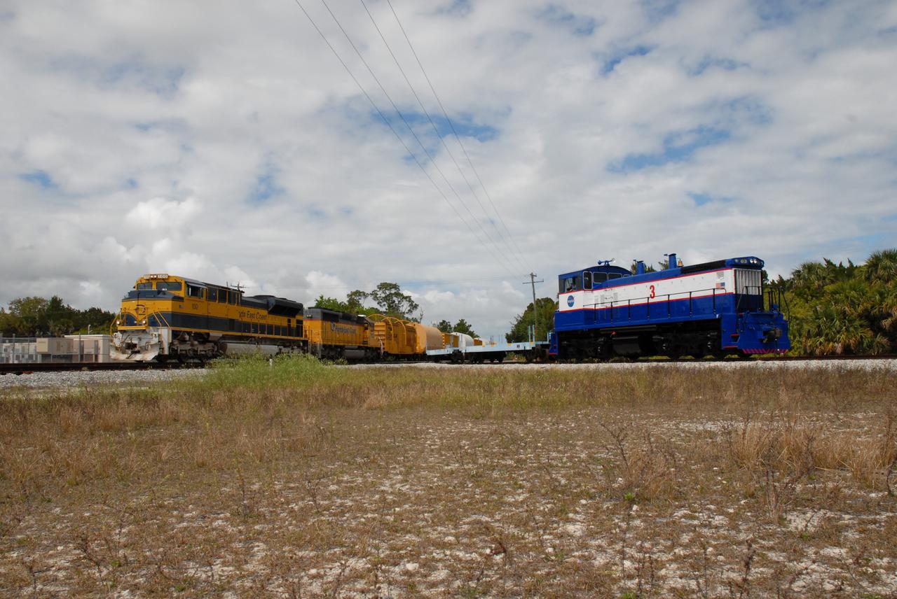CAPE CANAVERAL, Fla. – The NASA Railroad (right) is ready for the exchange of the Florida East Coast Railway cars carrying the booster segments for the Ares I-X test rocket. The four reusable motor segments and the nozzle exit cone, manufactured by the Ares I first-stage prime contractor Alliant Techsystems Inc., or ATK, departed Utah March 12 on the seven-day, cross-country trip to Florida.  The segments will be delivered to the  Rotation, Processing and Surge Facility for final processing and integration. The booster used for the Ares I-X launch is being modified by adding new forward structures and a fifth segment simulator. The motor is the final hardware needed for the rocket's upcoming test flight this summer. The stacking operations are scheduled to begin in the Vehicle Assembly Building in April.   Photo credit: NASA/Kim Shiflett