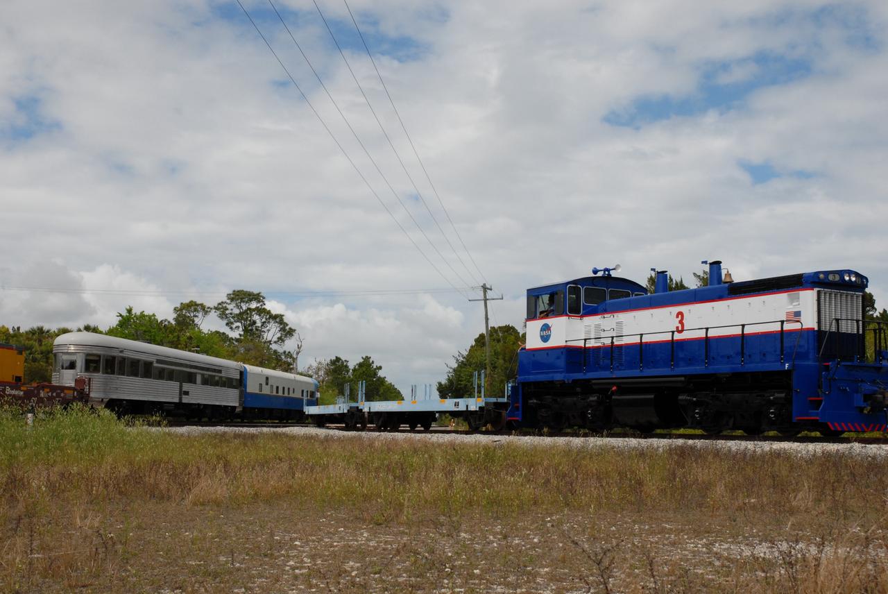 CAPE CANAVERAL, Fla. – – The NASA Railroad (right) is ready for the exchange of the Florida East Coast Railway cars carrying the booster segments for the Ares I-X test rocket. The four reusable motor segments and the nozzle exit cone, manufactured by the Ares I first-stage prime contractor Alliant Techsystems Inc., or ATK, departed Utah March 12 on the seven-day, cross-country trip to Florida.  The segments will be delivered to the  Rotation, Processing and Surge Facility for final processing and integration. The booster used for the Ares I-X launch is being modified by adding new forward structures and a fifth segment simulator. The motor is the final hardware needed for the rocket's upcoming test flight this summer. The stacking operations are scheduled to begin in the Vehicle Assembly Building in April.   Photo credit: NASA/Kim Shiflett