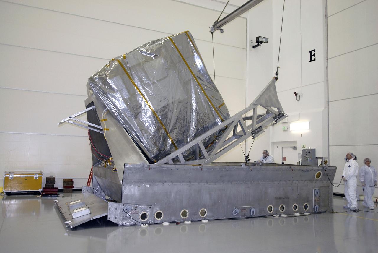 CAPE CANAVERAL, Fla. – At the Astrotech payload processing facility in Titusville, Fla., the GOES-O satellite is lifted out of its shipping container.  It will be placed on a stand for final testing of the imaging system, instrumentation, communications and power systems.   The latest Geostationary Operational Environmental Satellite, GOES-O was developed by NASA for the National Oceanic and Atmospheric Administration, or NOAA. The GOES-O satellite is targeted to launch April 28 onboard a United Launch Alliance Delta IV expendable launch vehicle. Once in orbit, GOES-O will be designated GOES-14, and NASA will provide on-orbit checkout and then transfer operational responsibility to NOAA. GOES-O will be placed in on-orbit storage as a replacement for an older GOES satellite. GOES-O carries an advanced attitude control system using star trackers with spacecraft optical bench Imager and Sounder mountings that provide enhanced instrument pointing performance for improved image navigation and registration to better locate severe storms and other events important to the NOAA National Weather Service.  Photo credit: NASA/Kim Shiflett