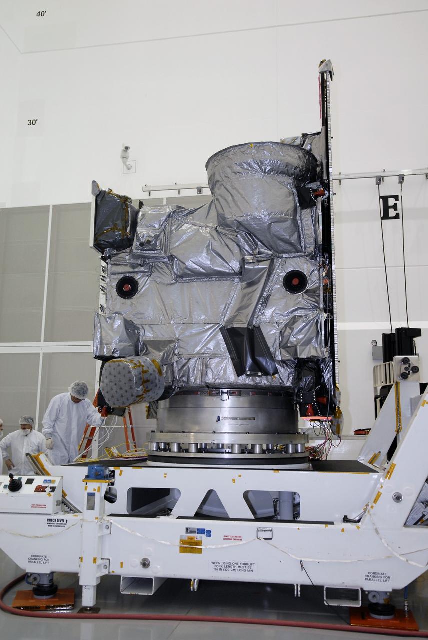 CAPE CANAVERAL, Fla. – At the Astrotech payload processing facility in Titusville, Fla., the protective shipping cover has been removed from the GOES-O satellite. GOES-O will undergo final testing of the imaging system, instrumentation, communications and power systems. The latest Geostationary Operational Environmental Satellite, GOES-O was developed by NASA for the National Oceanic and Atmospheric Administration, or NOAA. The GOES-O satellite is targeted to launch April 28 onboard a United Launch Alliance Delta IV expendable launch vehicle. Once in orbit, GOES-O will be designated GOES-14, and NASA will provide on-orbit checkout and then transfer operational responsibility to NOAA. GOES-O will be placed in on-orbit storage as a replacement for an older GOES satellite. GOES-O carries an advanced attitude control system using star trackers with spacecraft optical bench Imager and Sounder mountings that provide enhanced instrument pointing performance for improved image navigation and registration to better locate severe storms and other events important to the NOAA National Weather Service. Photo credit: NASA/Kim Shiflett