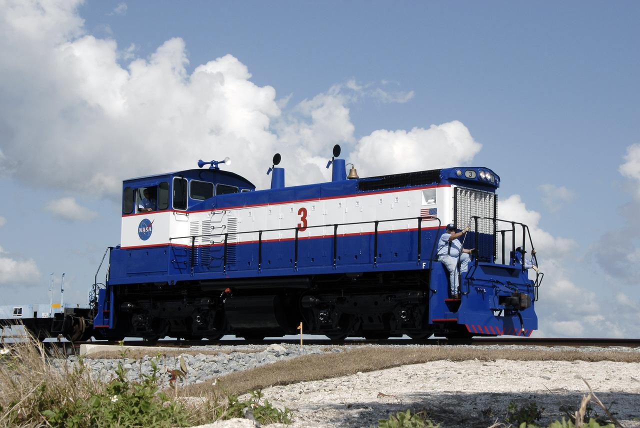 CAPE CANAVERAL, Fla. – A close-up of the NASA Railroad locomotive #3, and the EMDSW-1500 switcher, that is hauling the Ares I-X motor segments and nozzle exit cone to NASA's Kennedy Space Center in Florida.  The four reusable motor segments and the nozzle exit cone, manufactured by the Ares I first-stage prime contractor Alliant Techsystems Inc., or ATK, departed Utah March 12 on the seven-day, cross-country trip to Florida.  The segments will be delivered to Kennedy's  Rotation, Processing and Surge Facility for final processing and integration. The booster used for the Ares I-X launch is being modified by adding new forward structures and a fifth segment simulator. The motor is the final hardware needed for the rocket's upcoming test flight this summer. The stacking operations are scheduled to begin in the Vehicle Assembly Building in April.   Photo credit: NASA/Kim Shiflett