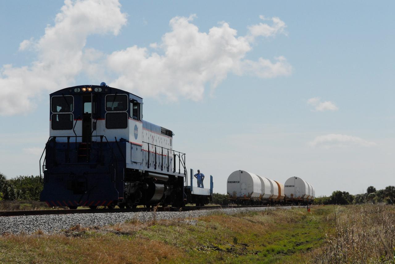 CAPE CANAVERAL, Fla. –The cars on the NASA Railroad are separated for different destinations at NASA's Kennedy Space Center in Florida.  They carry Ares I-X segments.  One of the cars is going to the Rotation, Processing and Surge Facility. The four reusable motor segments and the nozzle exit cone, manufactured by the Ares I first-stage prime contractor Alliant Techsystems Inc., or ATK, departed Utah March 12 on the seven-day, cross-country trip to Florida.  The segments will be delivered to Kennedy's  Rotation, Processing and Surge Facility for final processing and integration. The booster used for the Ares I-X launch is being modified by adding new forward structures and a fifth segment simulator. The motor is the final hardware needed for the rocket's upcoming test flight this summer. The stacking operations are scheduled to begin in the Vehicle Assembly Building in April.   Photo credit: NASA/Jack Pfaller