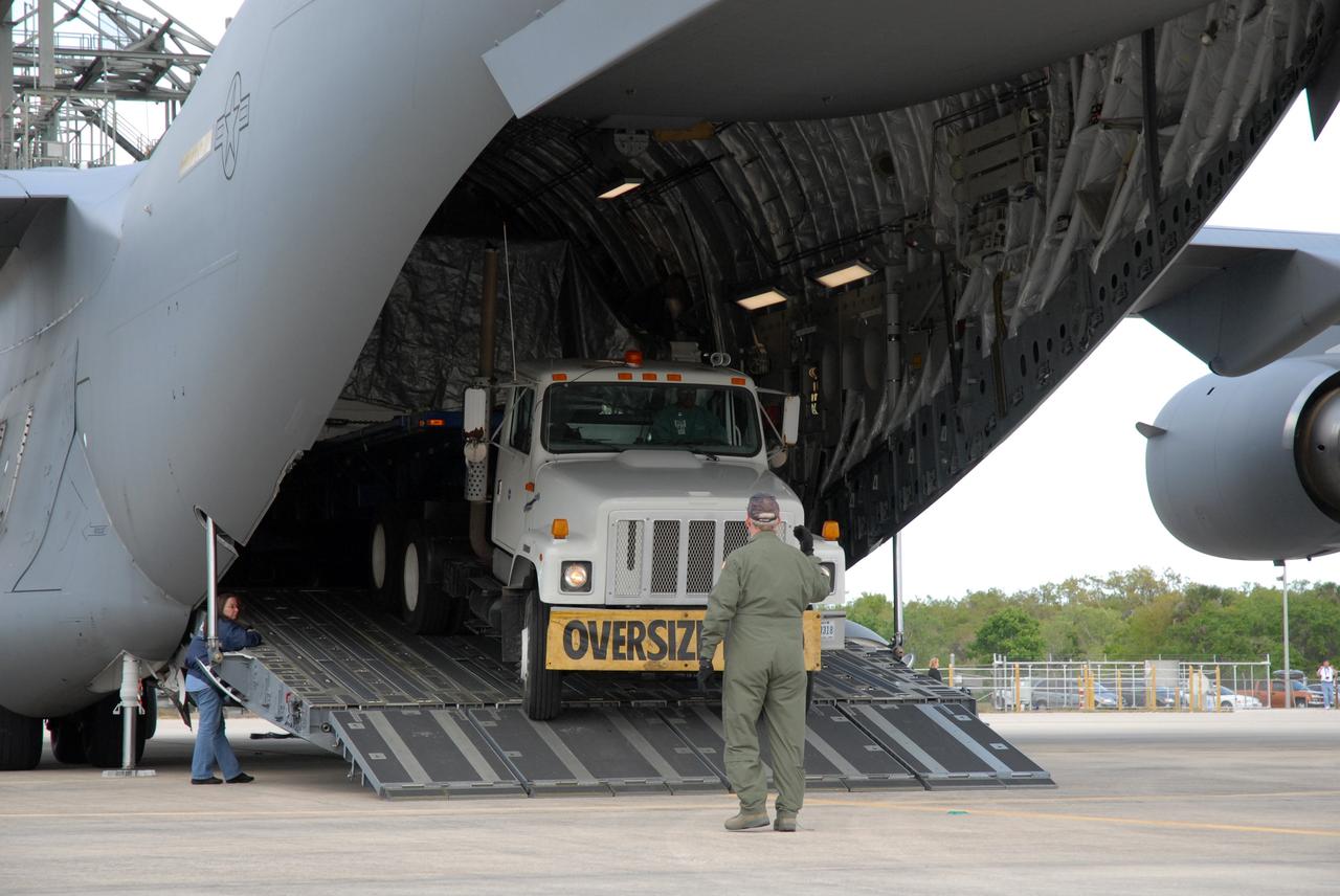 CAPE CANAVERAL, Fla. – On the Shuttle Landing Facility at NASA's Kennedy Space Center in Florida, a truck carrying the EXPRESS Logistics Carrier for the STS-129 mission drives out of the open rear of the C-17 cargo plane. The carrier is part of the payload on space shuttle Atlantis, which will deliver to the International Space Station components including two spare gyroscopes, two nitrogen tank assemblies, two pump modules, an ammonia tank assembly and a spare latching end effector for the station's robotic arm. STS-129 is targeted to launch Nov. 12. Photo credit: NASA/Tim Jacobs