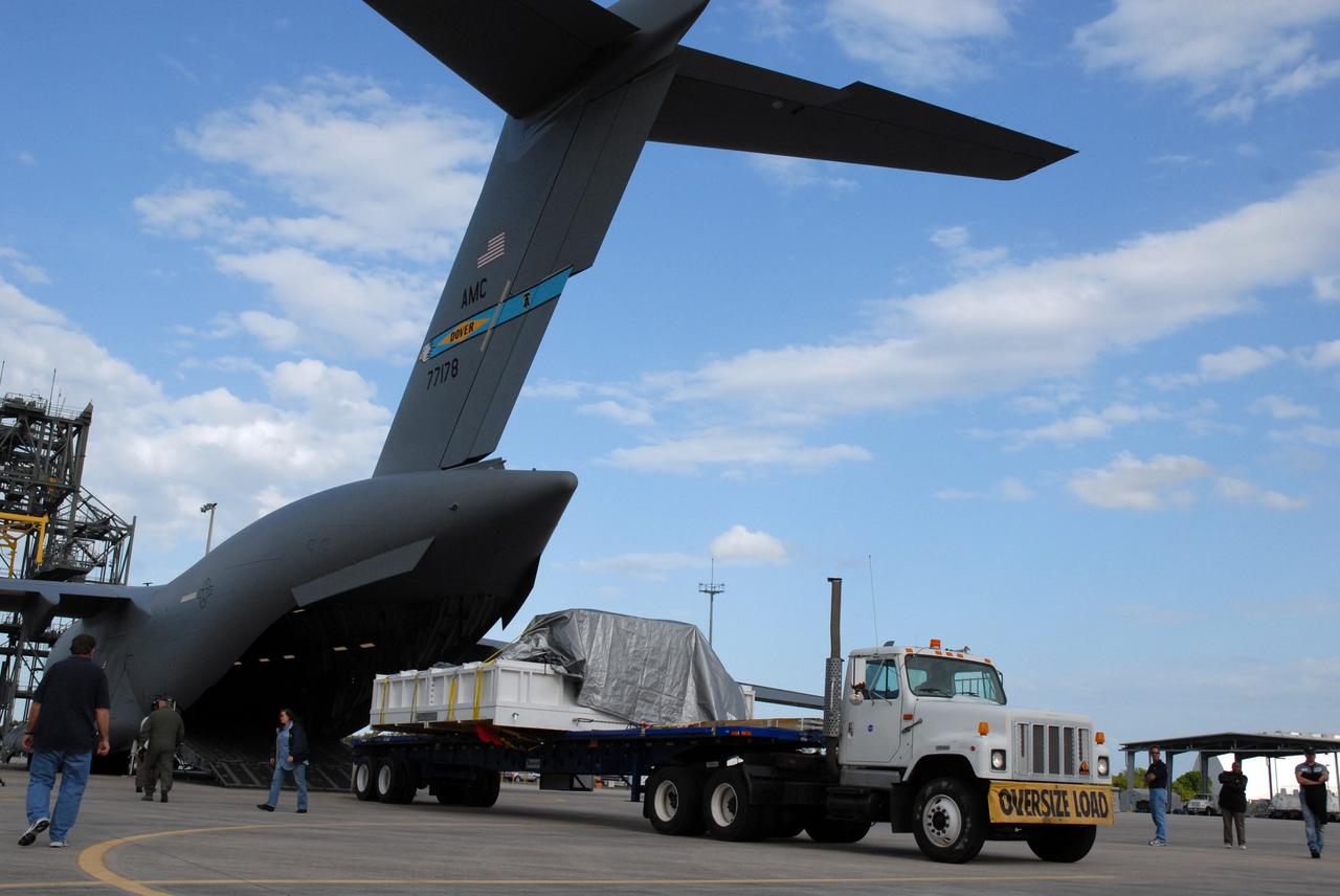 CAPE CANAVERAL, Fla. – The truck carrying the EXPRESS Logistics Carrier for the STS-129 mission pulls away from the C-17 cargo plane that delivered it to NASA's Kennedy Space Center in Florida. The carrier is part of the payload on space shuttle Atlantis, which will deliver to the International Space Station components including two spare gyroscopes, two nitrogen tank assemblies, two pump modules, an ammonia tank assembly and a spare latching end effector for the station's robotic arm. STS-129 is targeted to launch Nov. 12. Photo credit: NASA/Tim Jacobs