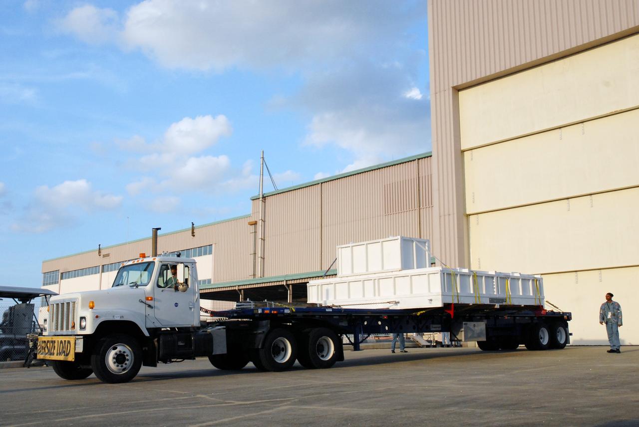 CAPE CANAVERAL, Fla. – The truck carrying the EXPRESS Logistics Carrier for the STS-129 mission arrives at the Space Station Processing Facility at NASA's Kennedy Space Center in Florida. The carrier is part of the payload on space shuttle Atlantis, which will deliver to the International Space Station components including two spare gyroscopes, two nitrogen tank assemblies, two pump modules, an ammonia tank assembly and a spare latching end effector for the station's robotic arm. STS-129 is targeted to launch Nov. 12. Photo credit: NASA/Tim Jacobs
