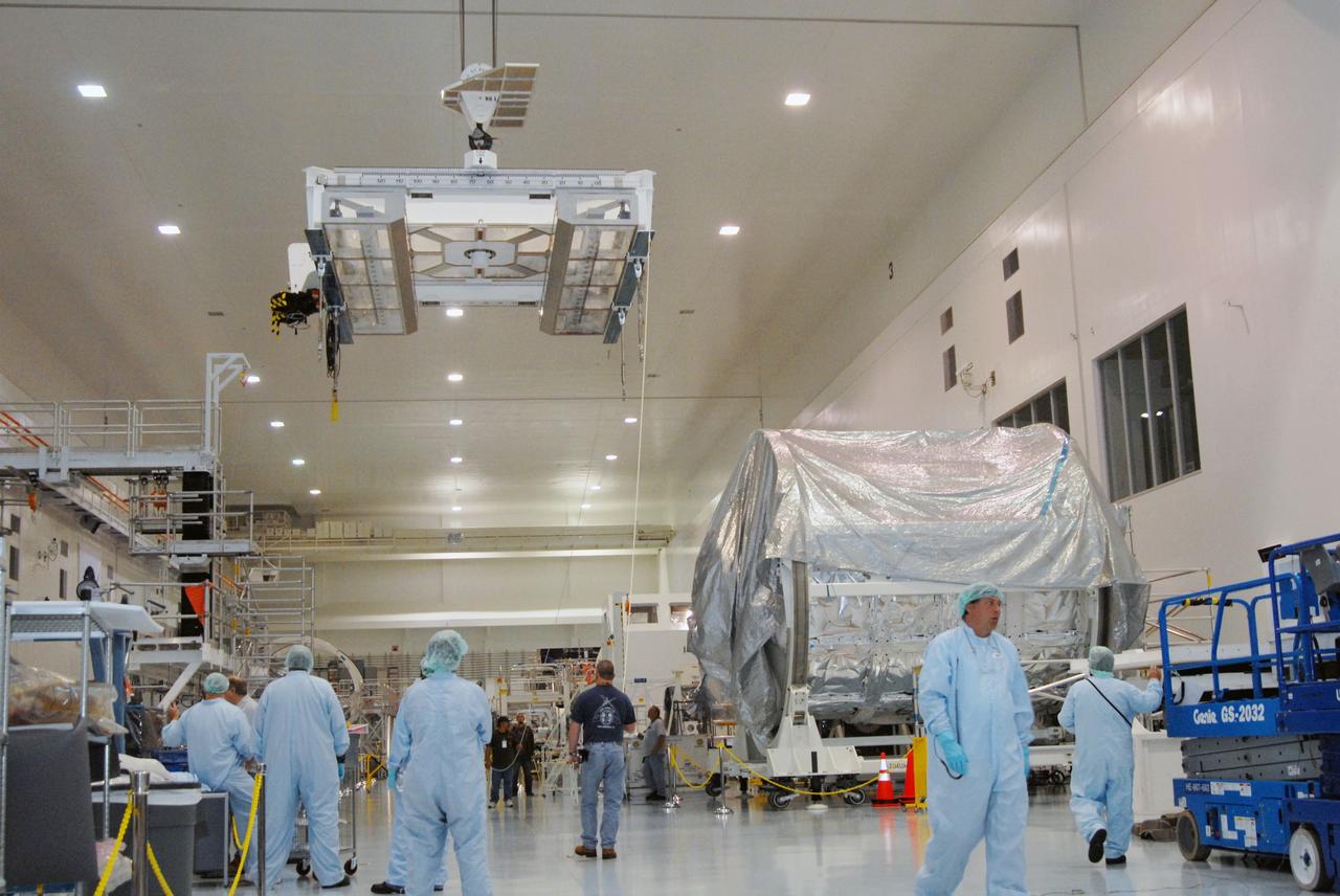 CAPE CANAVERAL, Fla. – Inside the Space Station Processing Facility at NASA's Kennedy Space Center in Florida, a strongback crane is being moved to the EXPRESS Logistics Carrier to lift it to a stand. The carrier is part of the payload on space shuttle Atlantis, which will deliver to the International Space Station components including two spare gyroscopes, two nitrogen tank assemblies, two pump modules, an ammonia tank assembly and a spare latching end effector for the station's robotic arm.  STS-129 is targeted to launch Nov. 12.  Photo credit: NASA/Tim Jacobs