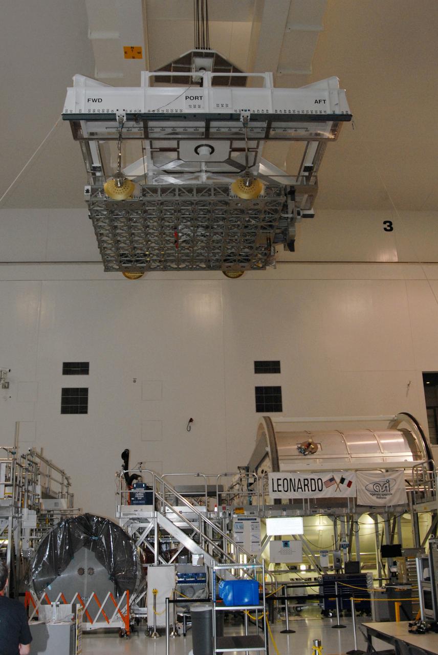 CAPE CANAVERAL, Fla. – Inside the Space Station Processing Facility at NASA's Kennedy Space Center in Florida, a crane carries the EXPRESS Logistics Carrier toward a stand. The carrier is part of the payload on space shuttle Atlantis, which will deliver to the International Space Station components including two spare gyroscopes, two nitrogen tank assemblies, two pump modules, an ammonia tank assembly and a spare latching end effector for the station's robotic arm.  STS-129 is targeted to launch Nov. 12.  Photo credit: NASA/Tim Jacobs