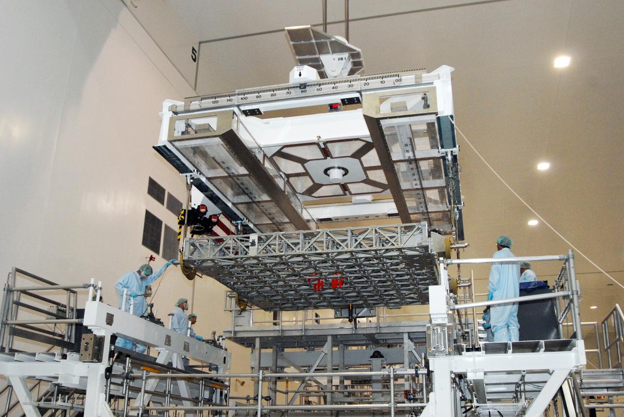 CAPE CANAVERAL, Fla. – Inside the Space Station Processing Facility at NASA's Kennedy Space Center in Florida, a crane lowers the EXPRESS Logistics Carrier onto a stand. The carrier is part of the payload on space shuttle Atlantis, which will deliver to the International Space Station components including two spare gyroscopes, two nitrogen tank assemblies, two pump modules, an ammonia tank assembly and a spare latching end effector for the station's robotic arm.  STS-129 is targeted to launch Nov. 12.  Photo credit: NASA/Tim Jacobs