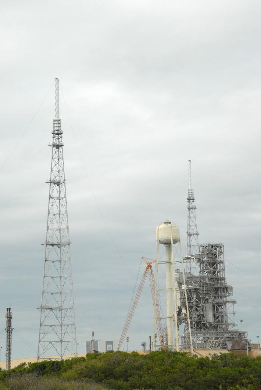 CAPE CANAVERAL, Fla. – On Launch Pad 39B at NASA's Kennedy Space Center in Florida, catenary wires are being suspended from the lighting masts on the lightning towers.  The catenary wire system under development for the Constellation Program’s next-generation vehicles will significantly increase the shielding level, providing better protection, and further separate the electrical current from vital launch hardware. The system will help avoid delays to the launch schedule by collecting more information on the strike for analysis by launch managers.  Photo credit: NASA/Jack Pfaller