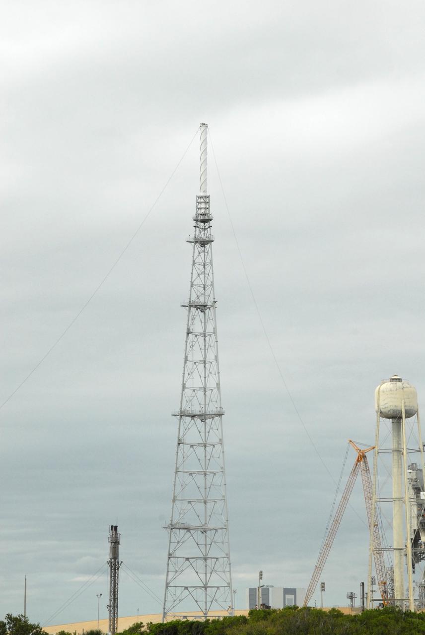 CAPE CANAVERAL, Fla. – On Launch Pad 39B at NASA's Kennedy Space Center in Florida, catenary wires are being suspended from the lighting masts on the lightning towers.  The catenary wire system under development for the Constellation Program’s next-generation vehicles will significantly increase the shielding level, providing better protection, and further separate the electrical current from vital launch hardware. The system will help avoid delays to the launch schedule by collecting more information on the strike for analysis by launch managers.  Photo credit: NASA/Jack Pfaller