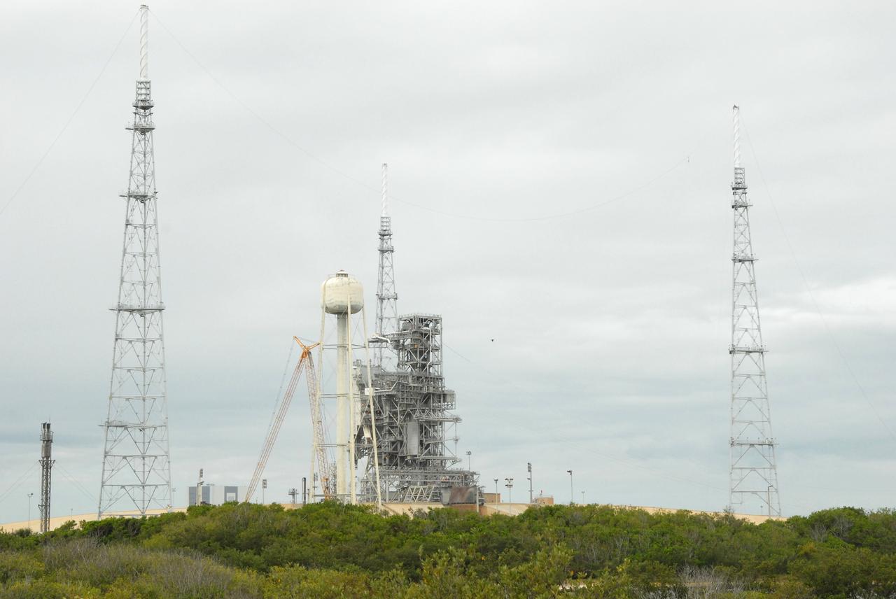 CAPE CANAVERAL, Fla. – On Launch Pad 39B at NASA's Kennedy Space Center in Florida, catenary wires are being suspended from the lighting masts on the lightning towers.  The catenary wire system under development for the Constellation Program’s next-generation vehicles will significantly increase the shielding level, providing better protection, and further separate the electrical current from vital launch hardware. The system will help avoid delays to the launch schedule by collecting more information on the strike for analysis by launch managers.  Photo credit: NASA/Jack Pfaller